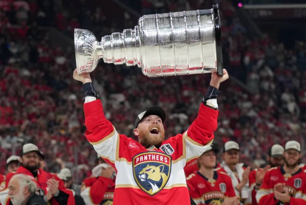 Jun 17, 2025; Sunrise, Florida, USA; Florida Panthers center Sam Bennett (9) hoists the Stanley Cup after winning game six of the 2025 Stanley Cup Final against the Edmonton Oilers at Amerant Bank Arena.