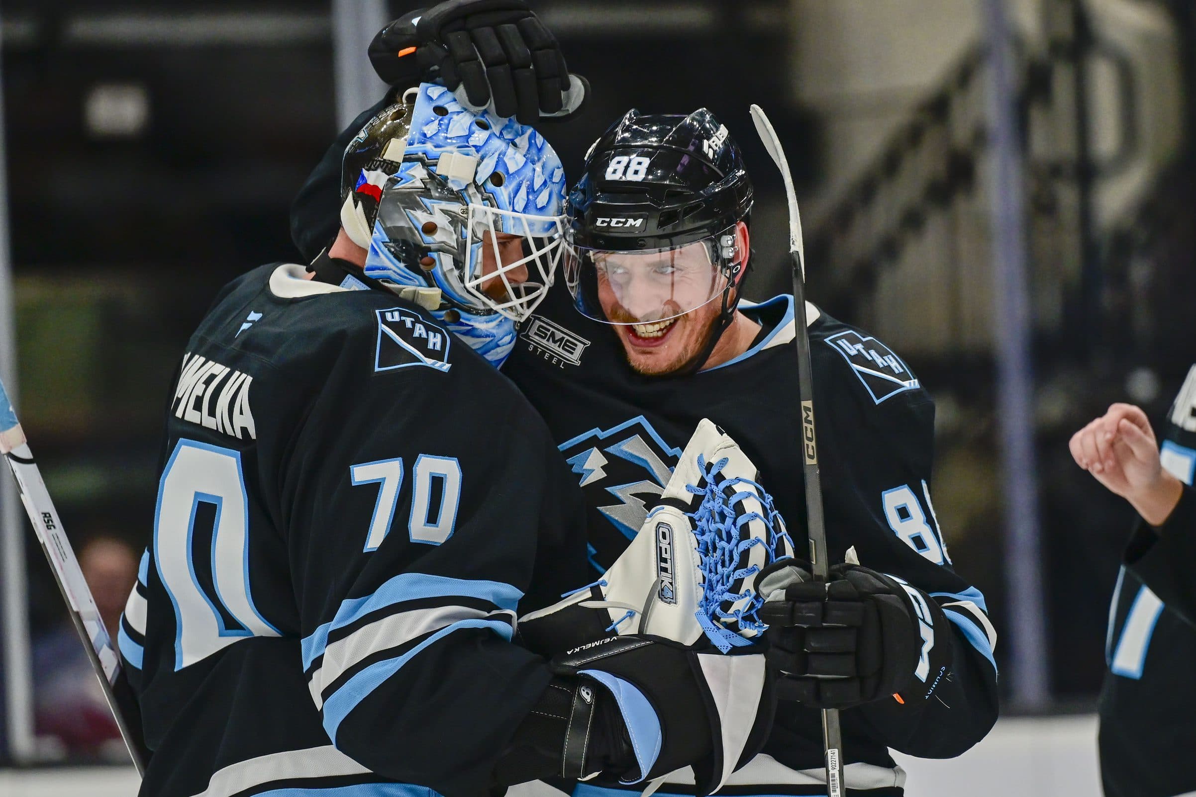 Utah Mammoth goalie Karel Vejmelka (70) and Utah Mammoth defenseman Nate Schmidt (88) celebrate their win after the game against the Seattle Kraken at Delta Center.