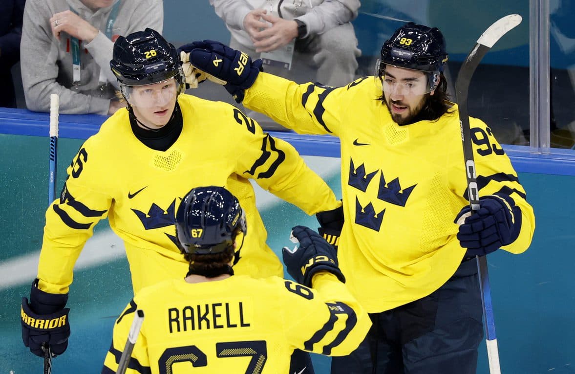 Mika Zibanejad of Sweden celebrates scoring their fourth goal with Rasmus Dahlin of Sweden and Rickard Rakell of Sweden against Italy in men's ice hockey group B play during the Milano Cortina 2026 Olympic Winter Games at Milano Santagiulia Ice Hockey Arena.