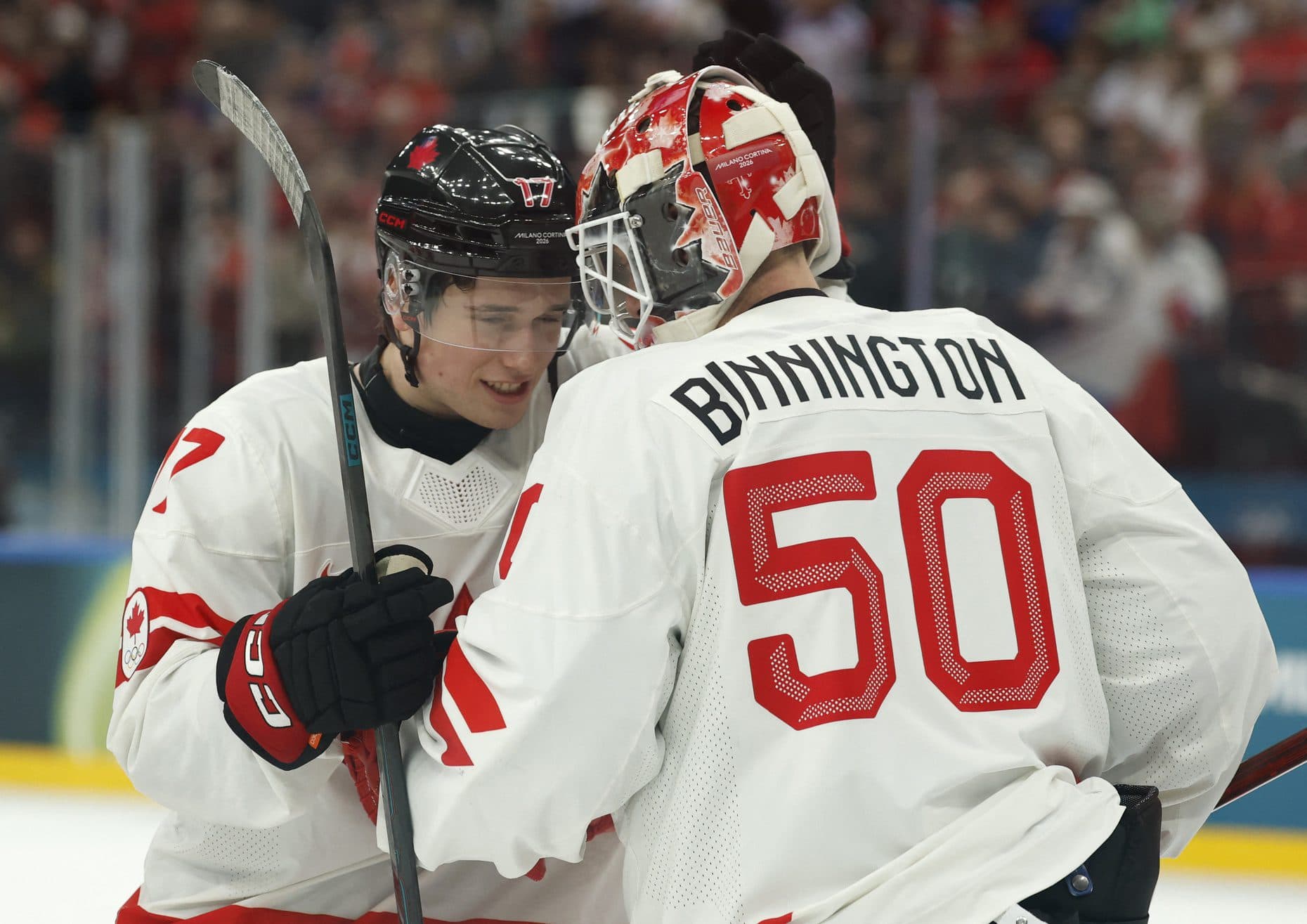 Macklin Celebrini and Jordan Binnington of Canada celebrate after the match against Czechia in a men's ice hockey group A match during the Milano Cortina 2026 Olympic Winter Games at Milano Santagiulia Ice Hockey Arena.