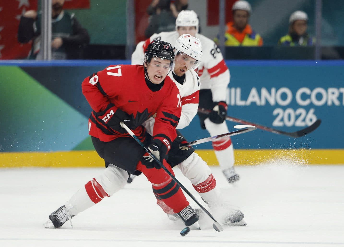 Macklin Celebrini of Canada in action with Pius Suter of Switzerland in men's ice hockey group A play during the Milano Cortina 2026 Olympic Winter Games at Milano Santagiulia Ice Hockey Arena.