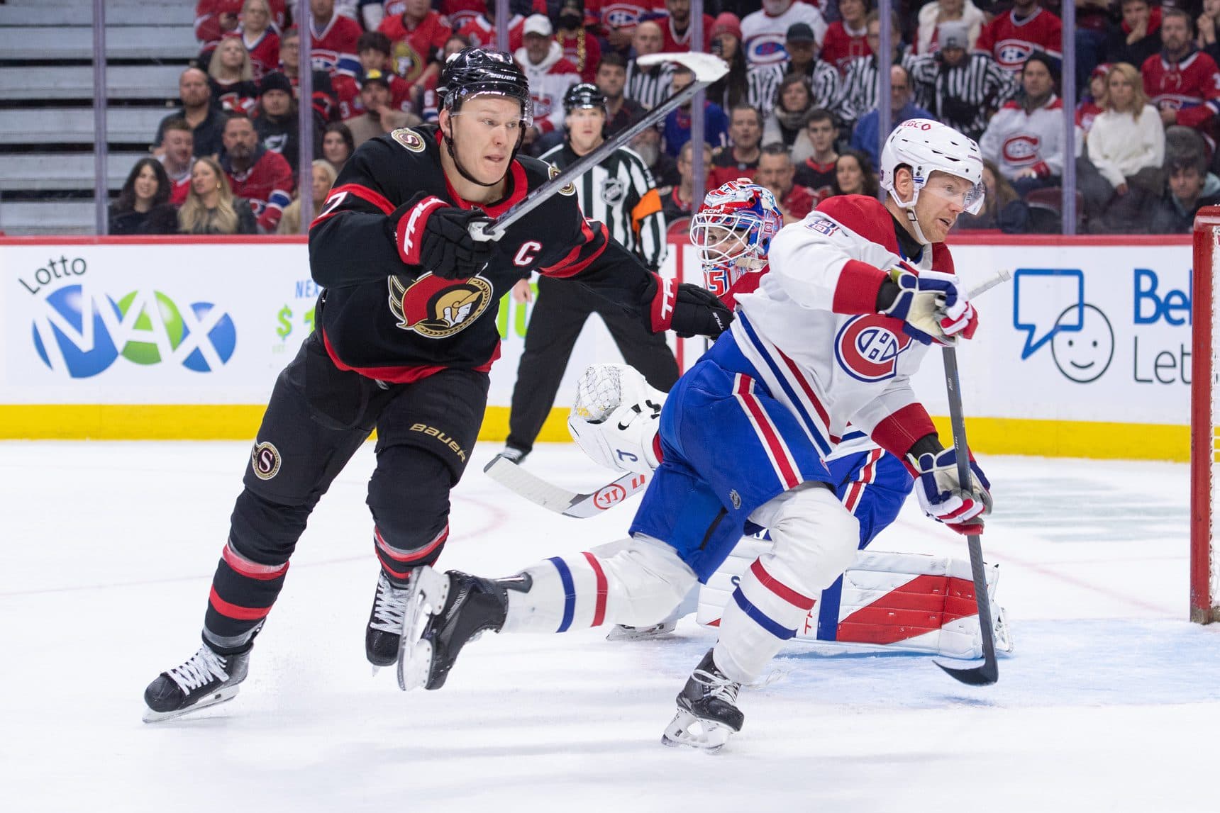 Ottawa Senators left wing Brady Tkachuk (7) and Montreal Canadiens defenseman Mike Matheson (8) chase the puck in the first period at the Canadian Tire Centre.