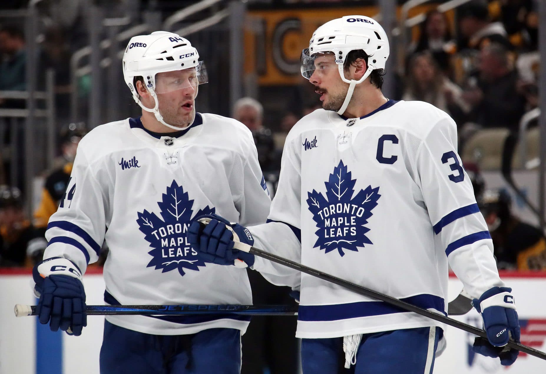 Toronto Maple Leafs defenseman Morgan Rielly (44) and center Auston Matthews (34) talk before a face-off against the Pittsburgh Penguins during the second period at PPG Paints Arena.