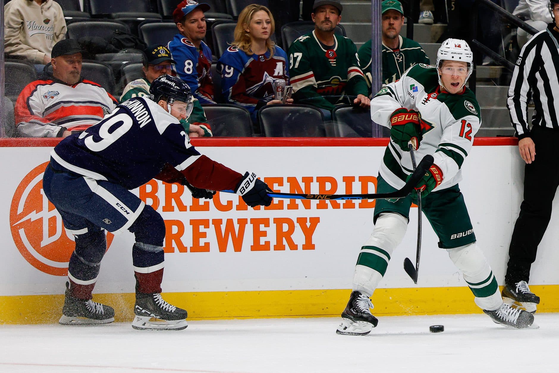 Minnesota Wild left wing Matt Boldy (12) scores his second open net goal as Colorado Avalanche center Nathan MacKinnon (29) defends in the third period at Ball Arena.