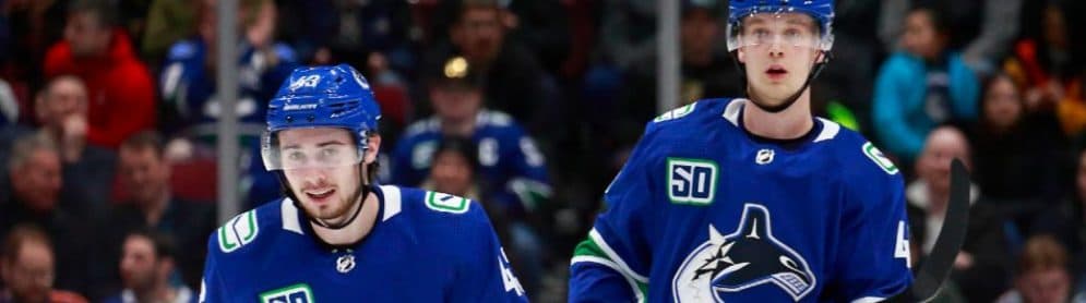Quinn Hughes and Elias Pettersson of the Vancouver Canucks. (Jeff Vinnick/NHLI via Getty Images)