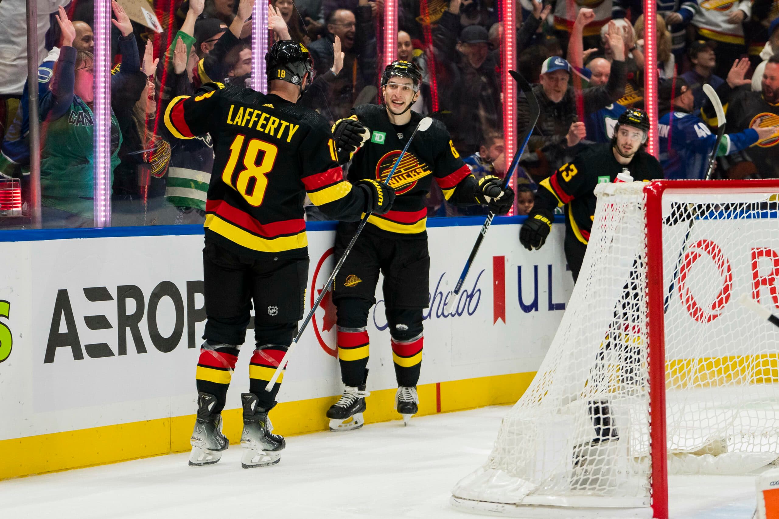 Ilya Mikheyev and Sam Lafferty of the Vancouver Canucks celebrate a goal.
