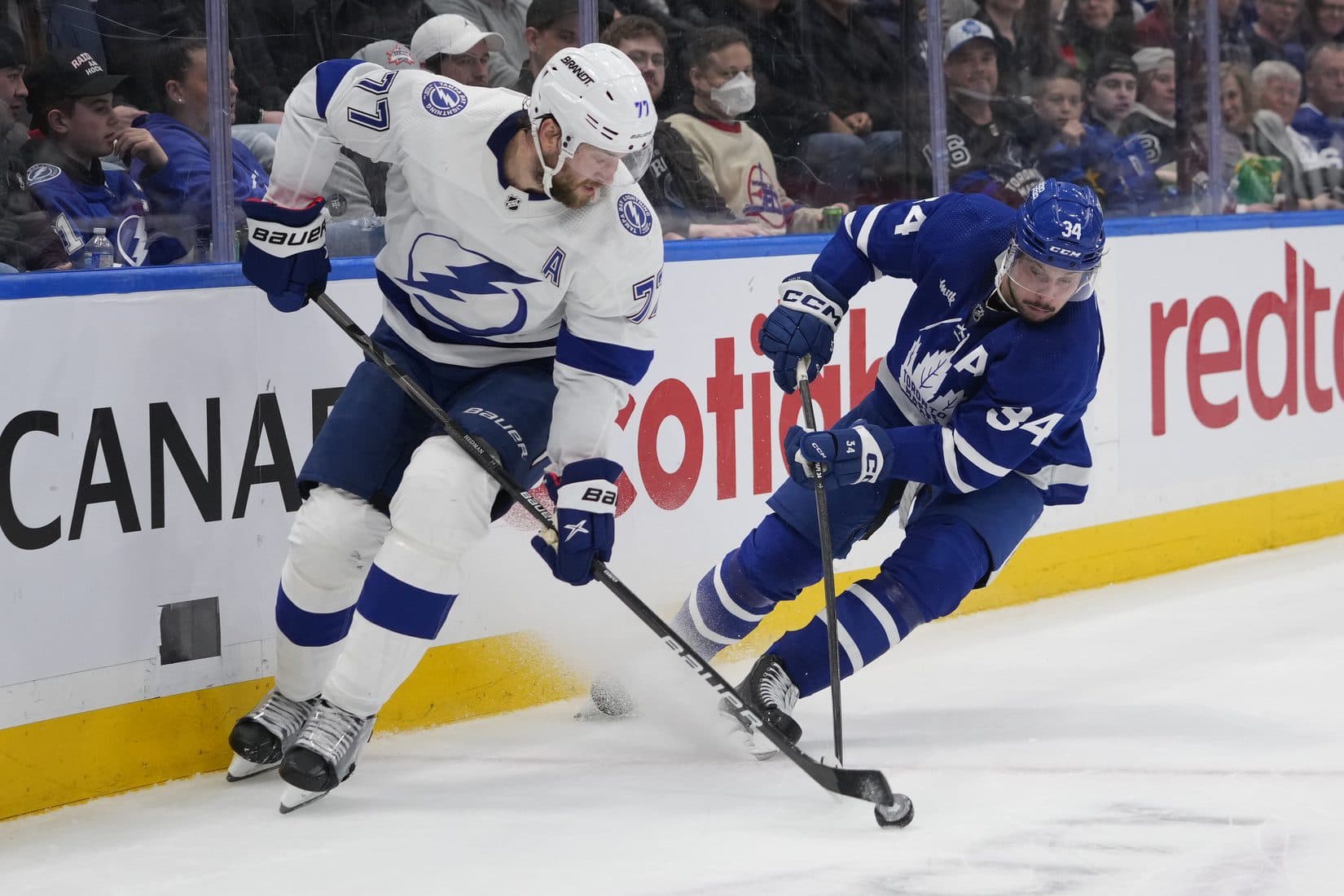 Tampa Bay Lightning defenseman Victor Hedman (77) and Toronto Maple Leafs forward Auston Matthews (34) battle for the puck during the second period at Scotiabank Arena.