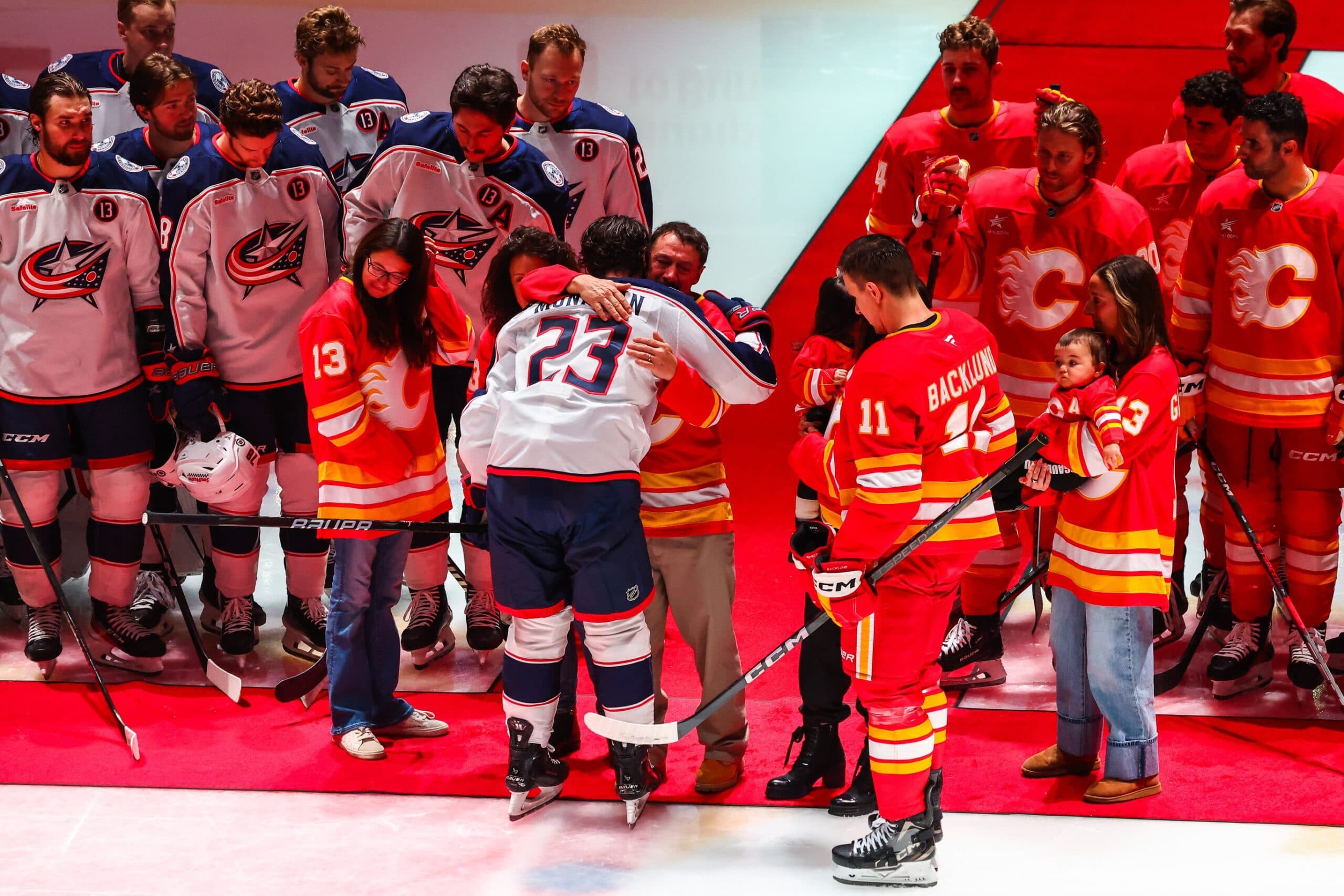 Johnny Gaudreaus family during ceremonial puck drop by Columbus Blue Jackets center Sean Monahan (23) and Calgary Flames center Mikael Backlund (11) during the first period at Scotiabank Saddledome.