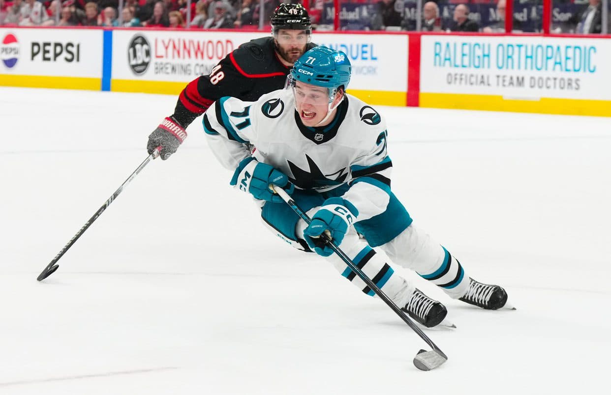 San Jose Sharks center Macklin Celebrini (71) skates with the puck against Carolina Hurricanes left wing Jordan Martinook (48) during the third period at Lenovo Center.