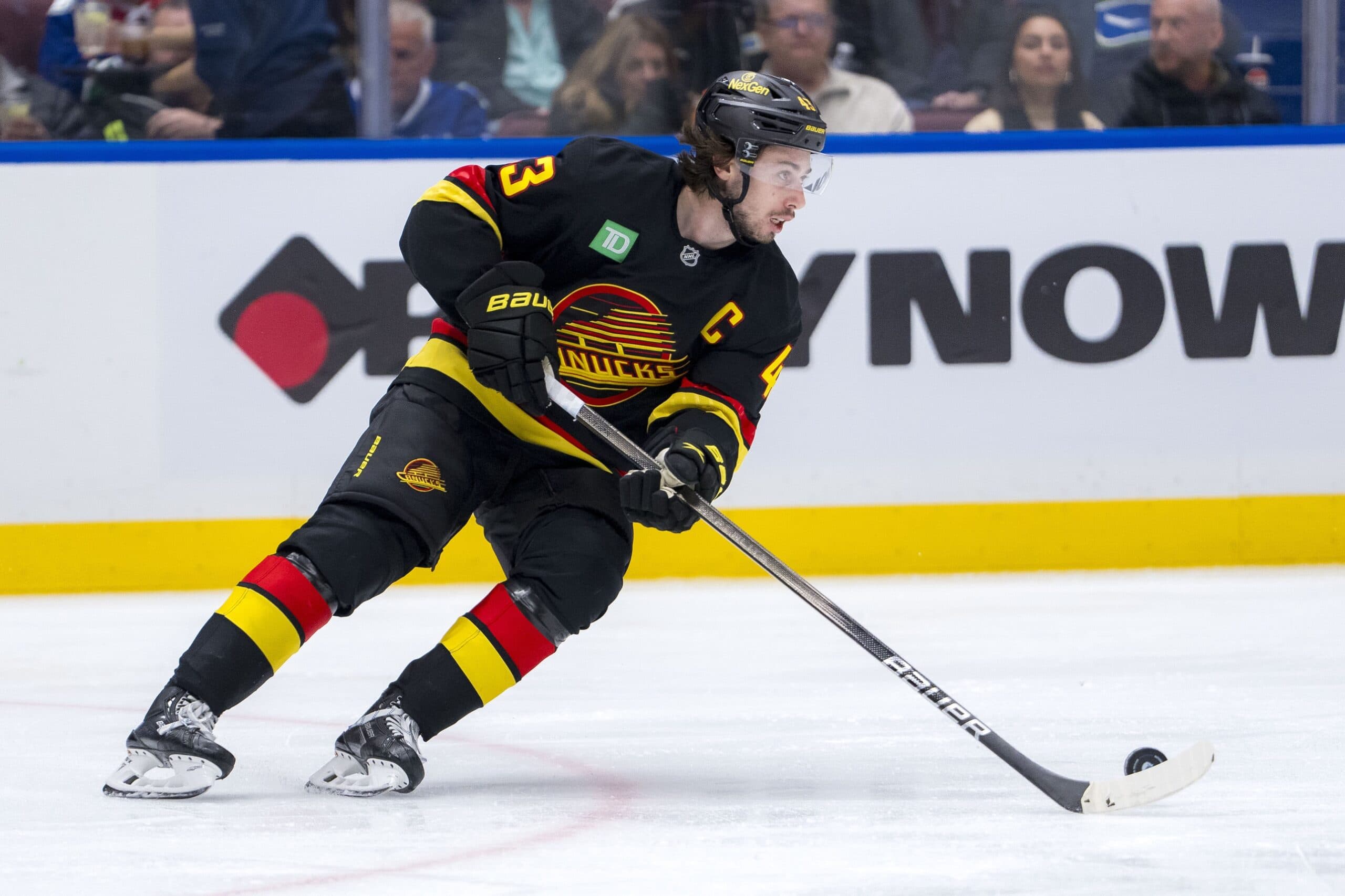 Vancouver Canucks defenseman Quinn Hughes (43) handles the puck against the Washington Capitals in the third period at Rogers Arena.