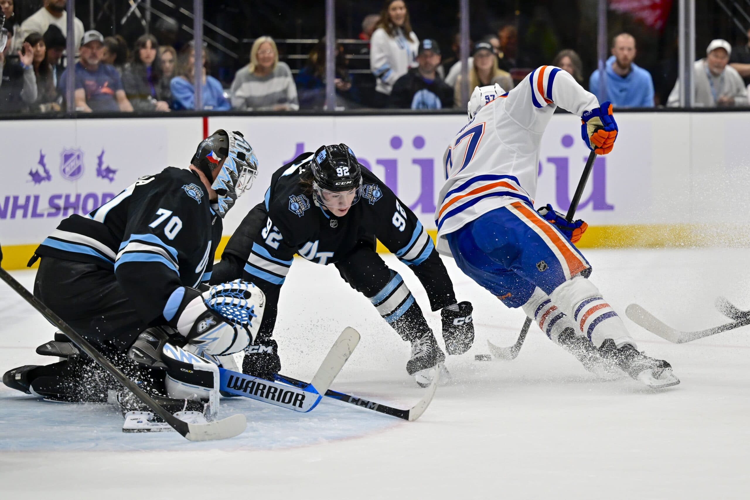 Edmonton Oilers center Connor McDavid (97) attempted a shot against Utah Hockey Club center Logan Cooley (92) and goaltender Karel Vejmelka (70) during the third period at the Delta Center.