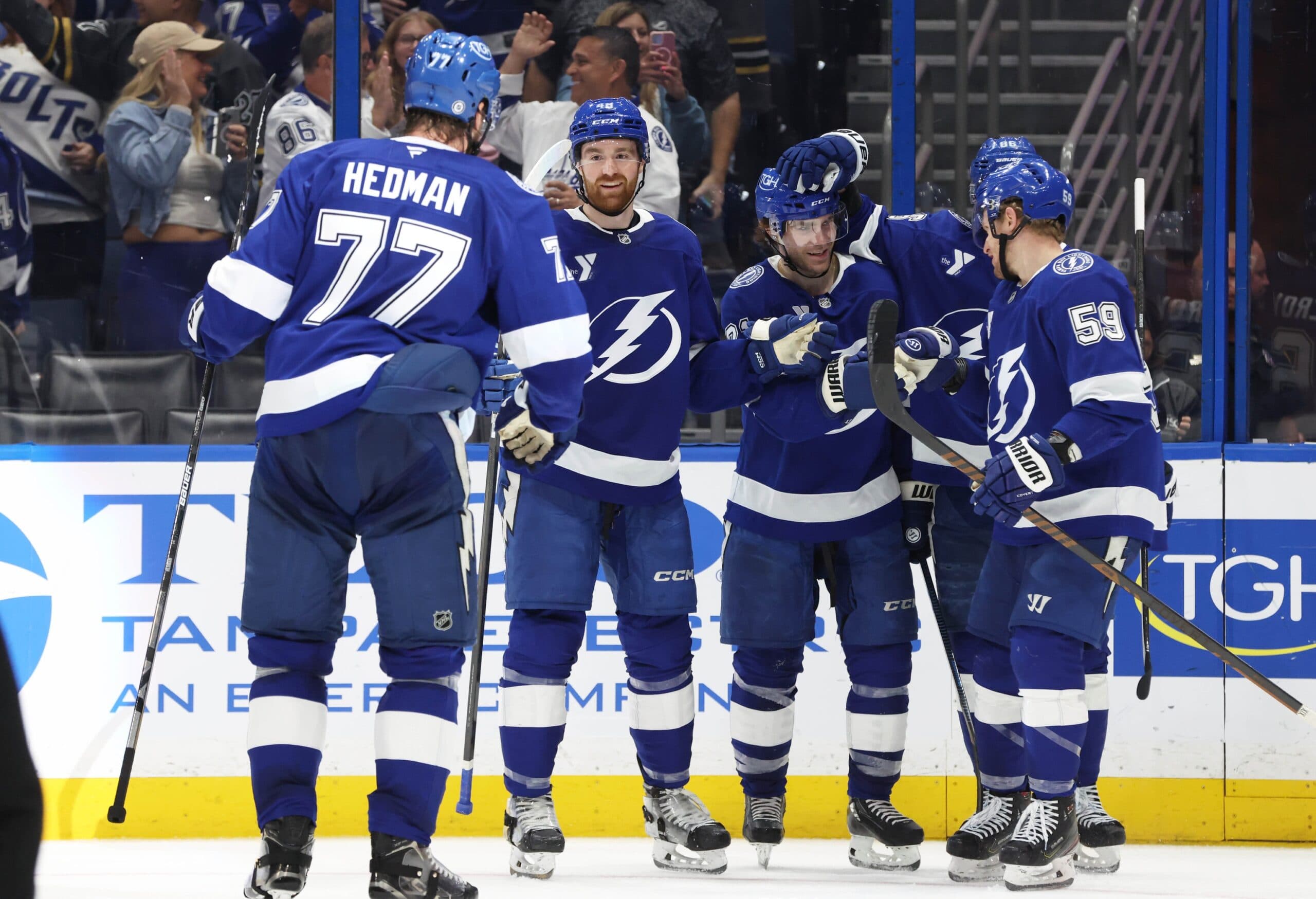 Tampa Bay Lightning center Brayden Point (21) is congratulated by defenseman Nick Perbix (48), defenseman Victor Hedman (77), center Jake Guentzel (59) and right wing Nikita Kucherov (86) after he scored a goal against the Utah Hockey Club during the third period at Amalie Arena.
