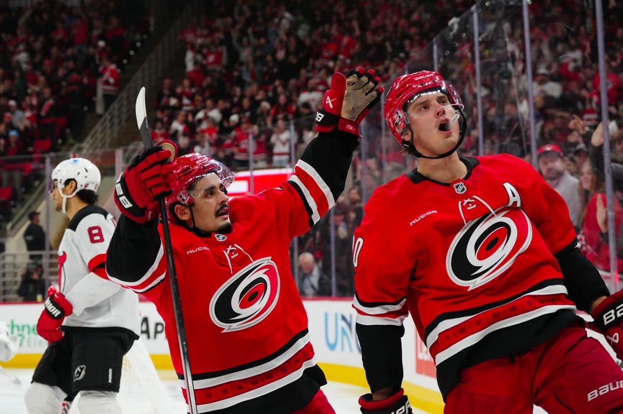 Carolina Hurricanes center Sebastian Aho (20) celebrates his goal with center Seth Jarvis (24) against the New Jersey Devils during the third period at Lenovo Center.