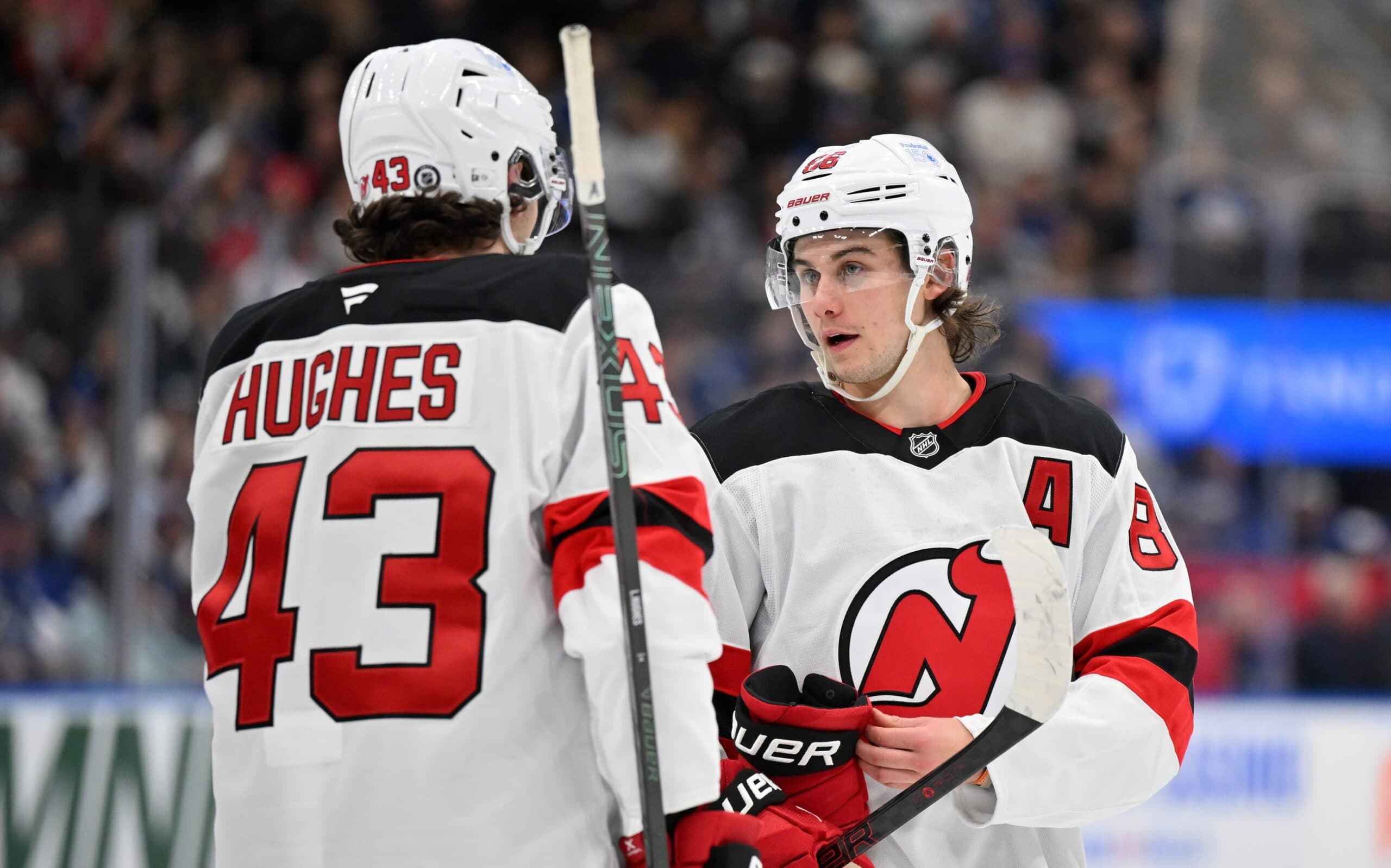 New Jersey Devils forward Jack Hughes (86) speaks to defenseman Luke Hughes (43) before a faceoff against the Toronto Maple Leafs in the second period at Scotiabank Arena.