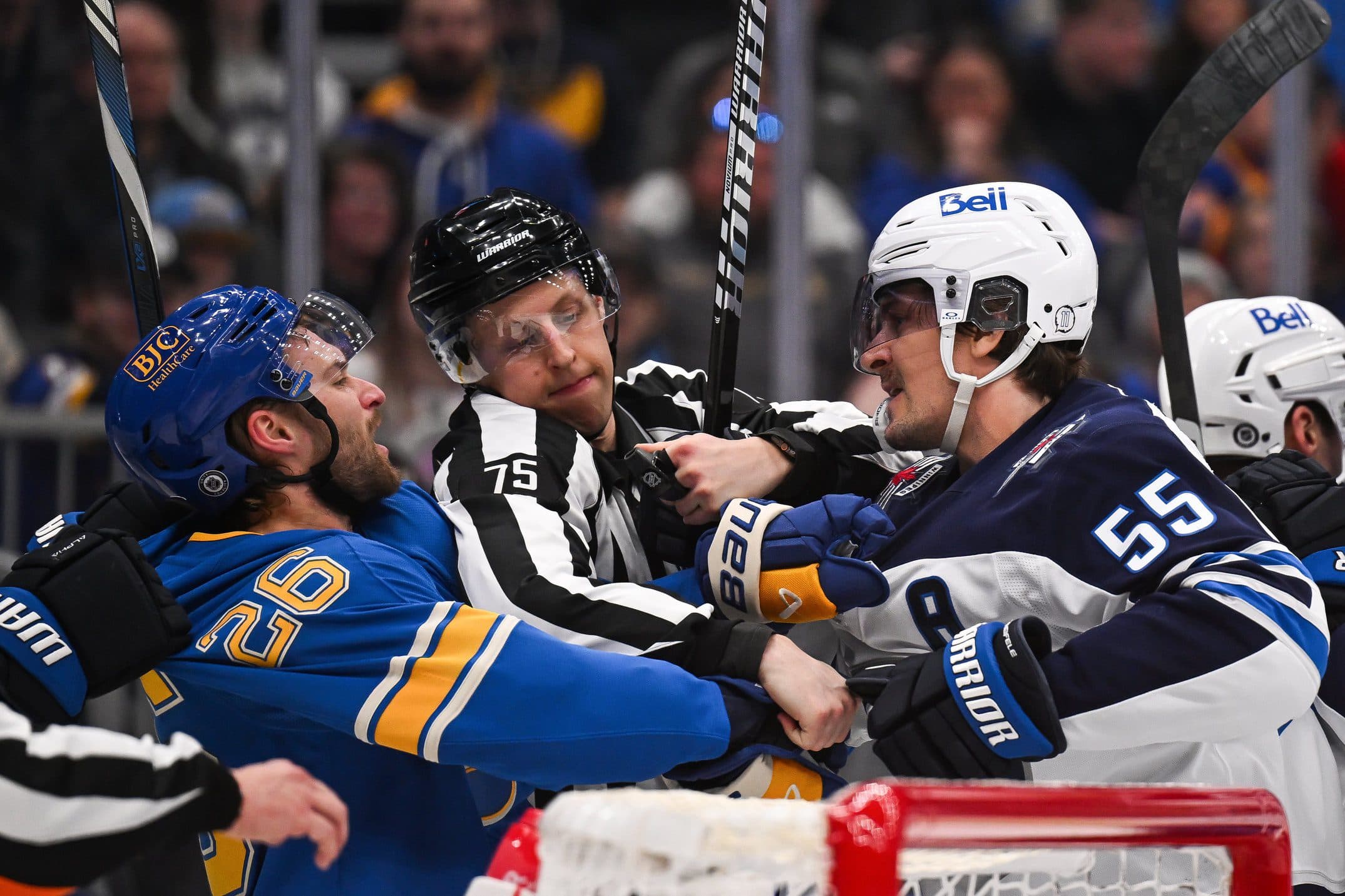 St. Louis Blues left wing Nathan Walker (26) and Winnipeg Jets center Mark Scheifele (55) get physical during the second period at Enterprise Center.