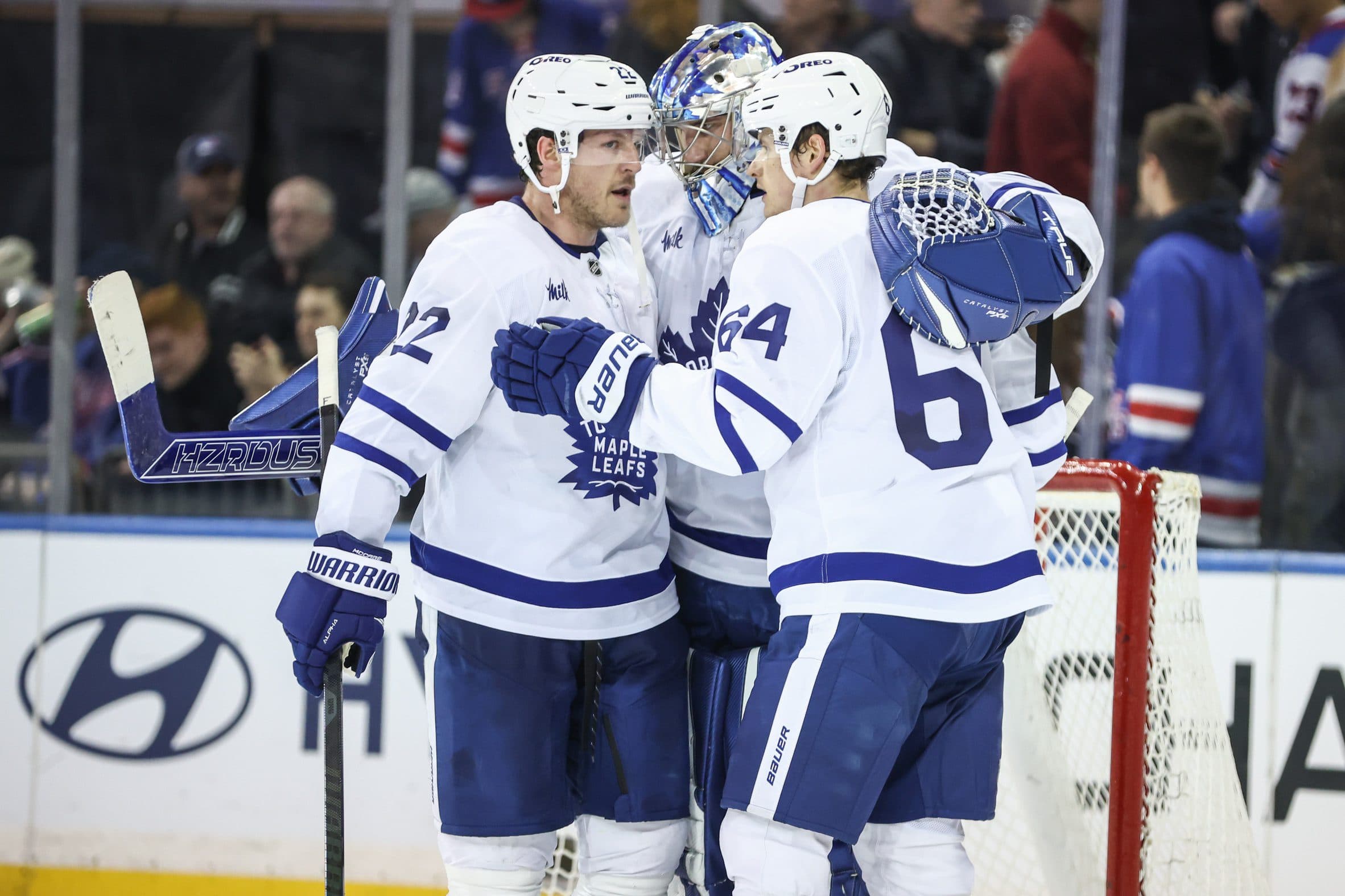 Toronto Maple Leafs goaltender Anthony Stolarz (41) celebrates with defenseman Jake McCabe (22) and center David Kampf (64) after defeating the New York Rangers at Madison Square Garden.