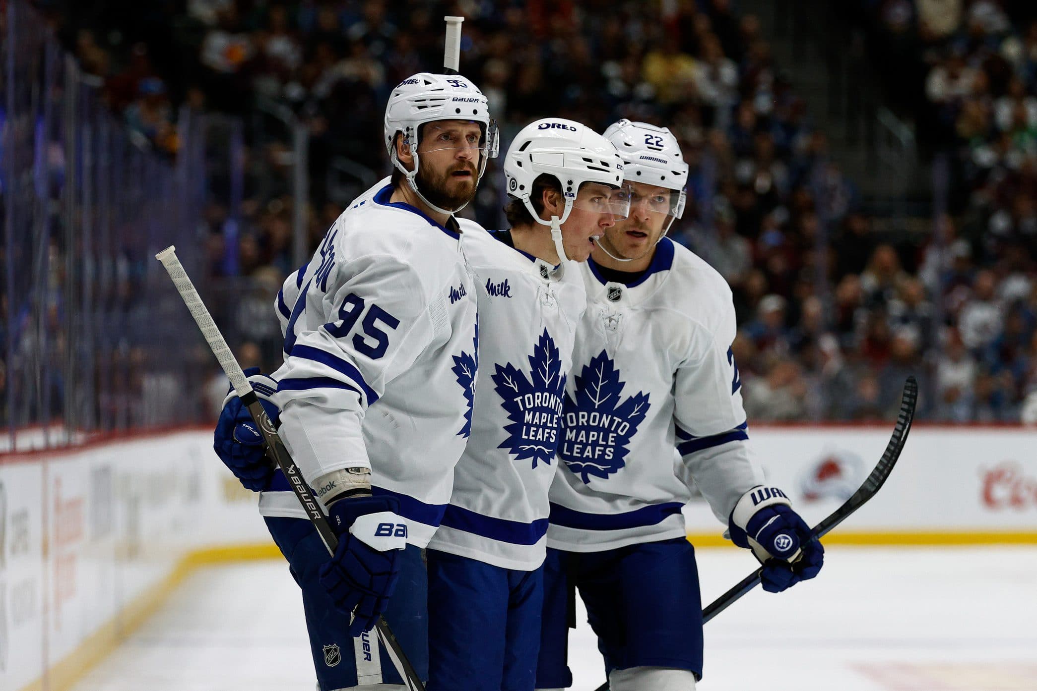 Toronto Maple Leafs right wing Mitch Marner (16) celebrates his goal with defenseman Oliver Ekman-Larsson (95) and defenseman Jake McCabe (22) in the first period against the Colorado Avalanche at Ball Arena.