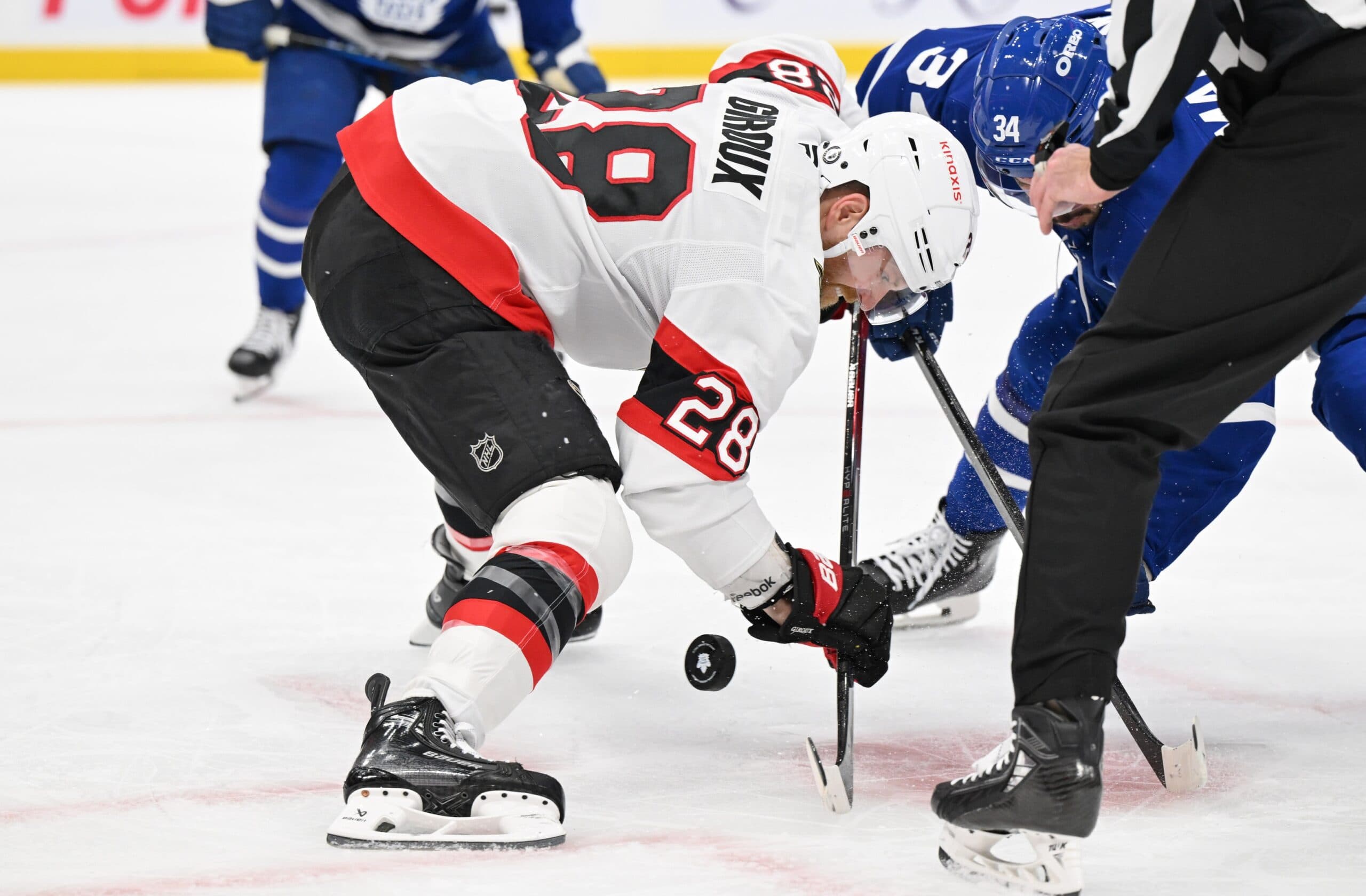 Ottawa Senators forward Claude Giroux (28) wins a face-off against Toronto Maple Leafs forward Auston Matthews (34) in the first period at Scotiabank Arena.