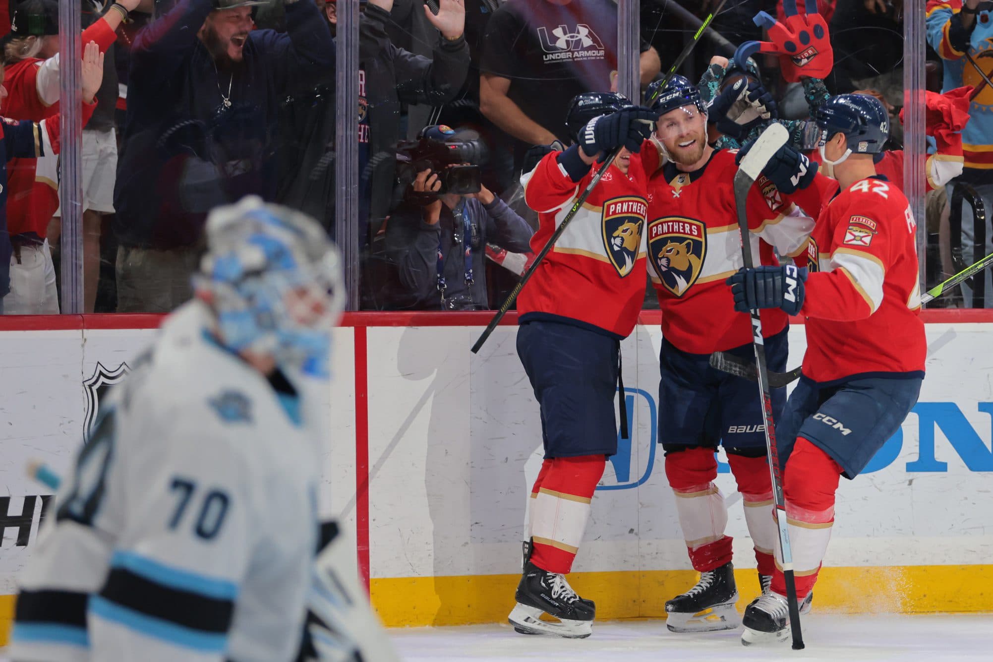 Florida Panthers center Sam Bennett (9) celebrates with teammates after scoring the game-winning goal against the Utah Hockey Club during overtime at Amerant Bank Arena.