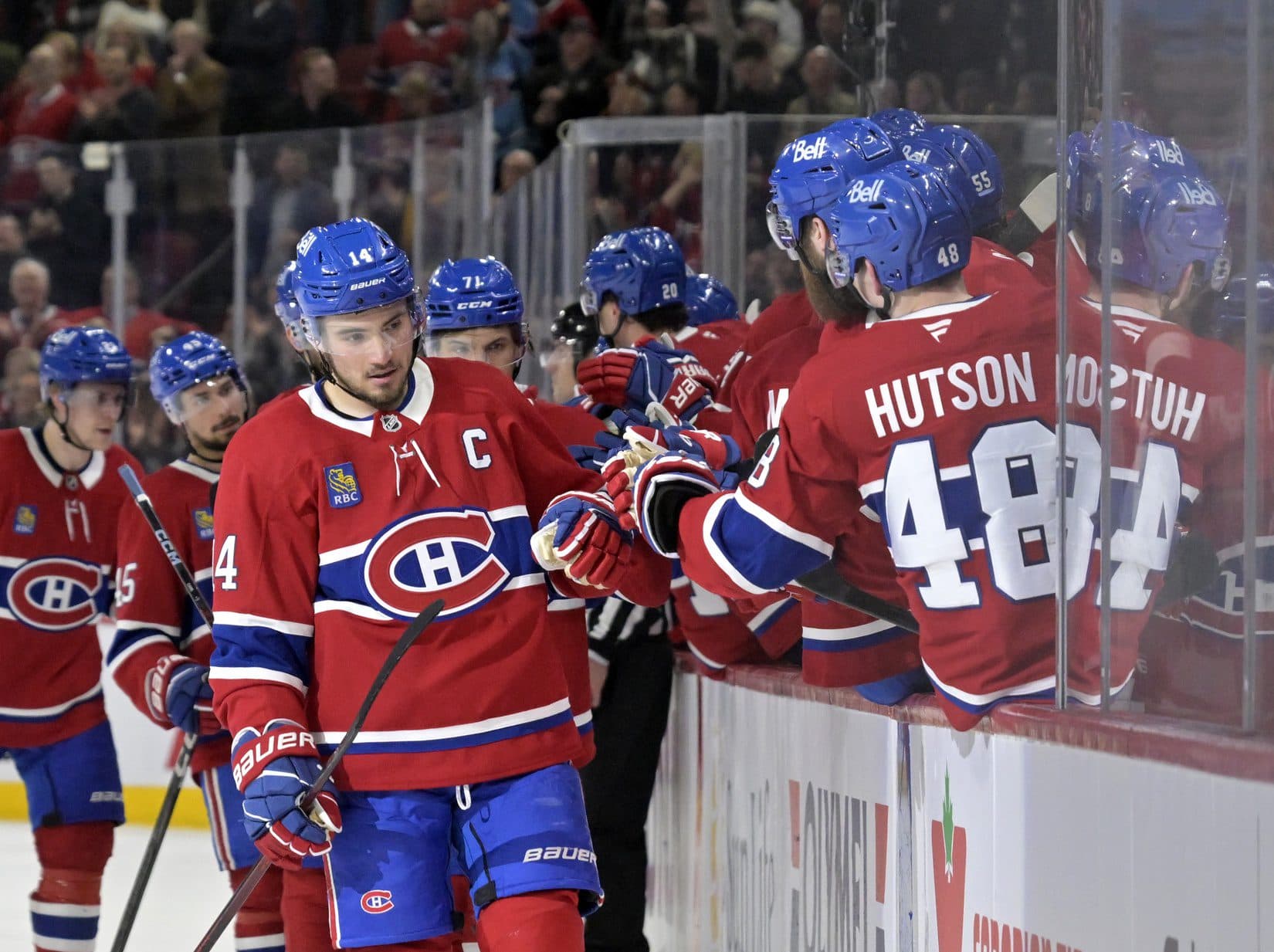 Montreal Canadiens forward Nick Suzuki (14) celebrates with teammates after scoring a goal against the Detroit Red Wings during the third period at the Bell Centre.