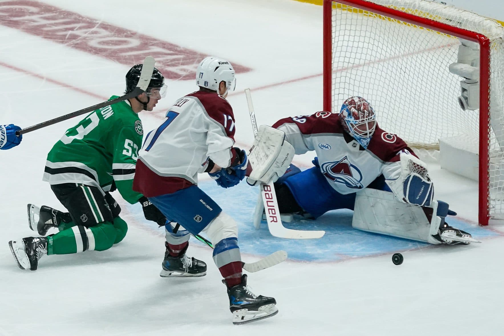 Colorado Avalanche goaltender Mackenzie Blackwood (39) prepares to make the save of a shot by Dallas Stars center Wyatt Johnston (53) as center Parker Kelly (17) looks on during the second period in game one of the first round of the 2025 Stanley Cup Playoffs at American Airlines Center.