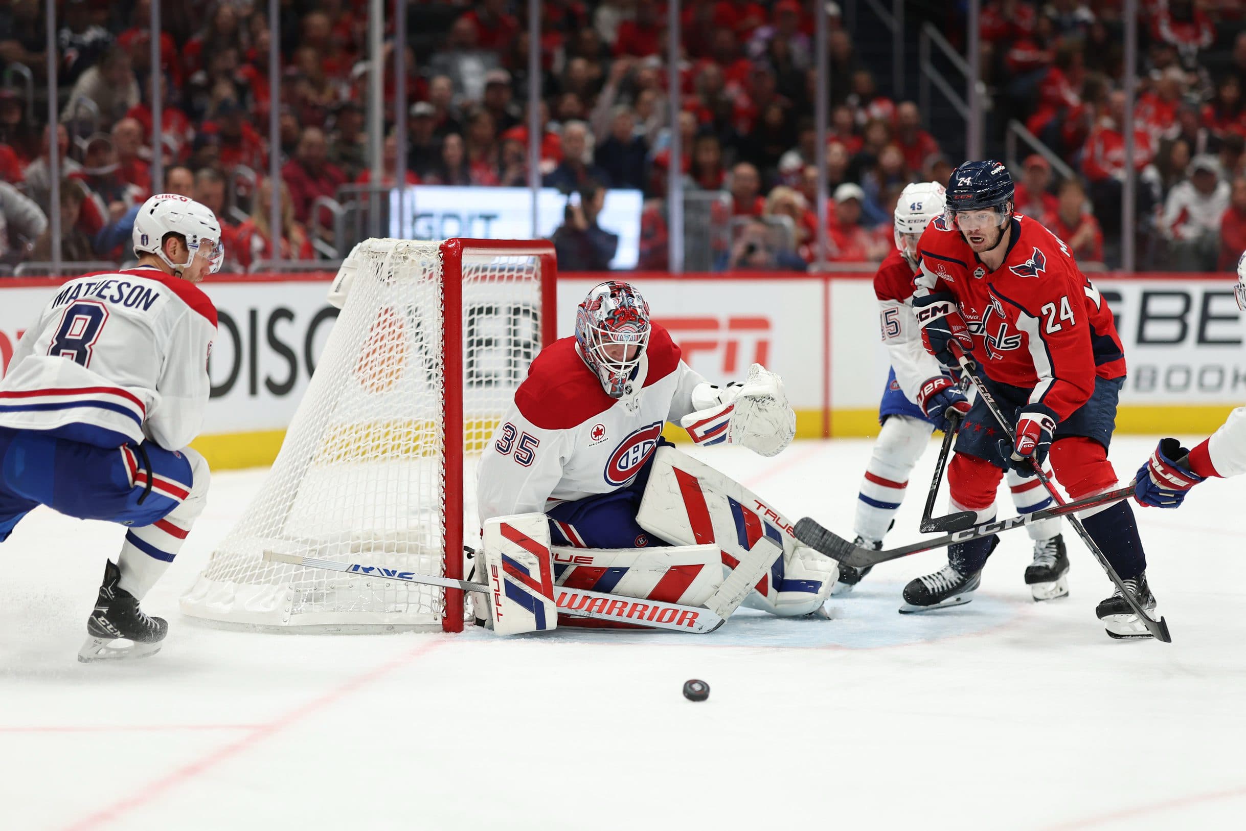Montreal Canadiens goaltender Sam Montembeault (35) makes a save in front of Washington Capitals center Connor McMichael (24) in the third period in game one of the first round of the 2025 Stanley Cup Playoffs at Capital One Arena
