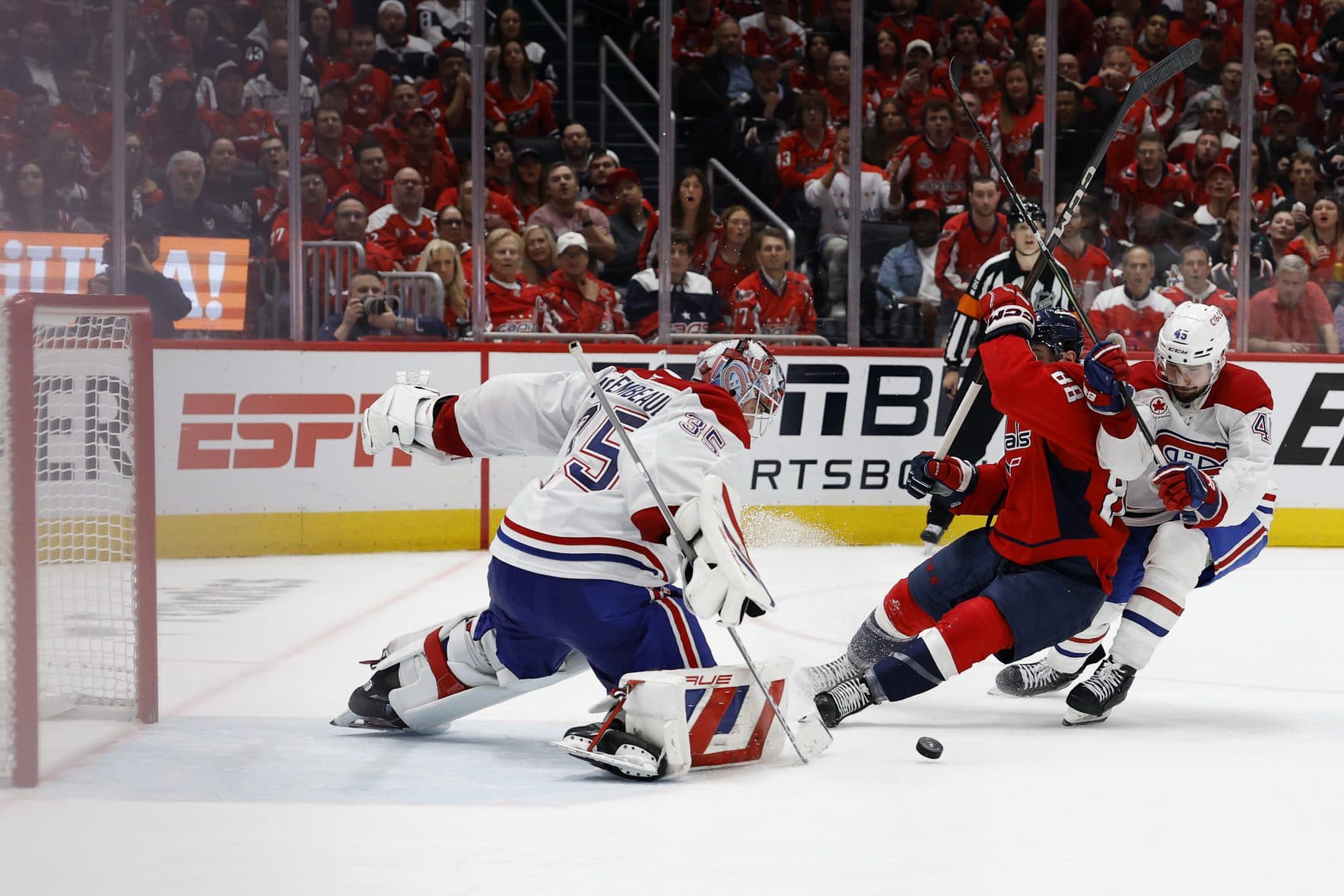 Montreal Canadiens goaltender Sam Montembeault (35) makes a save on Washington Capitals left wing Andrew Mangiapane (88) as Canadiens defenseman Alexandre Carrier (45) defends in the third period in game two of the first round of the 2025 Stanley Cup Playoffs at Capital One Arena