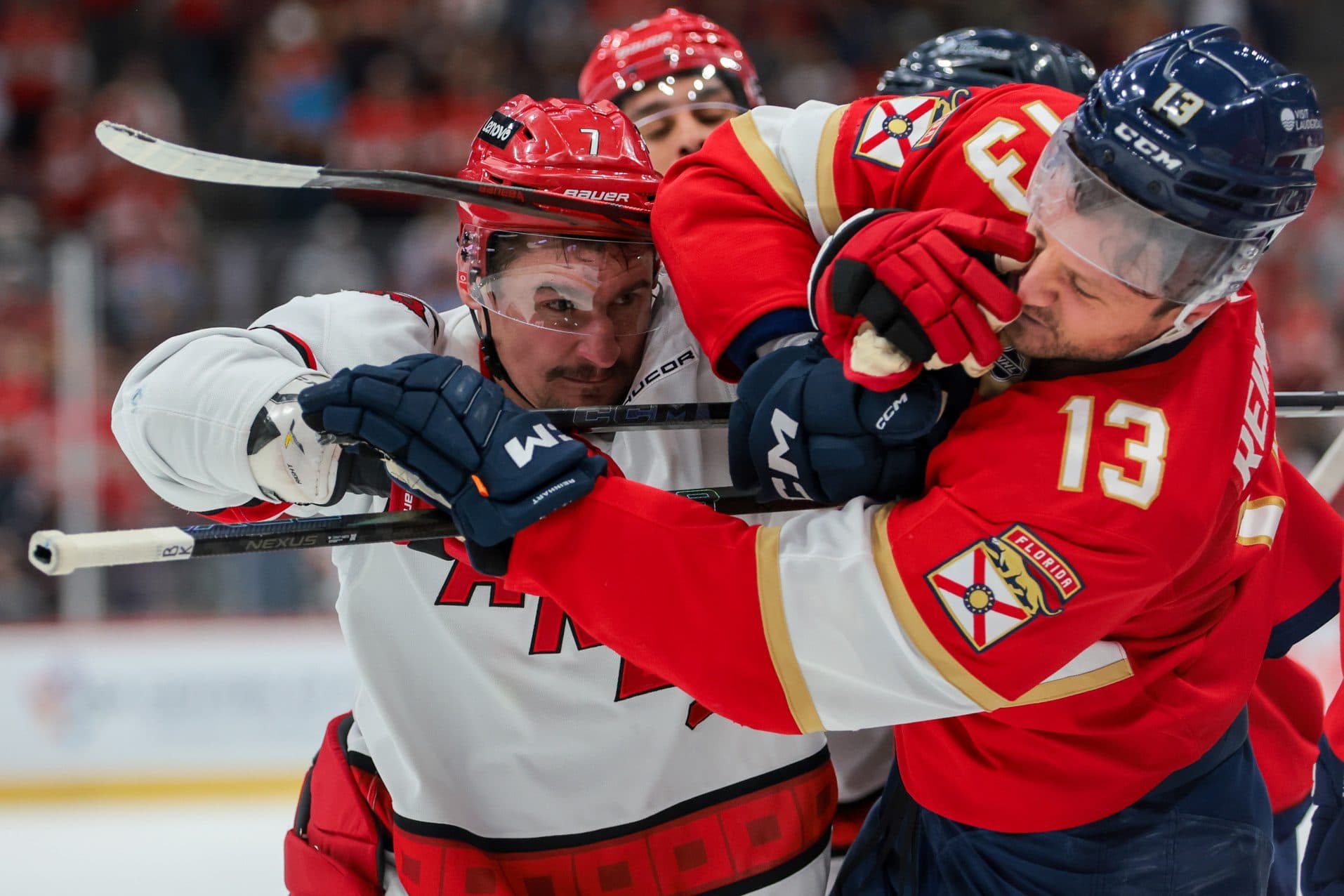 Carolina Hurricanes defenseman Dmitry Orlov (7) hits Florida Panthers center Sam Reinhart (13) at the ned of the first period at Amerant Bank Arena