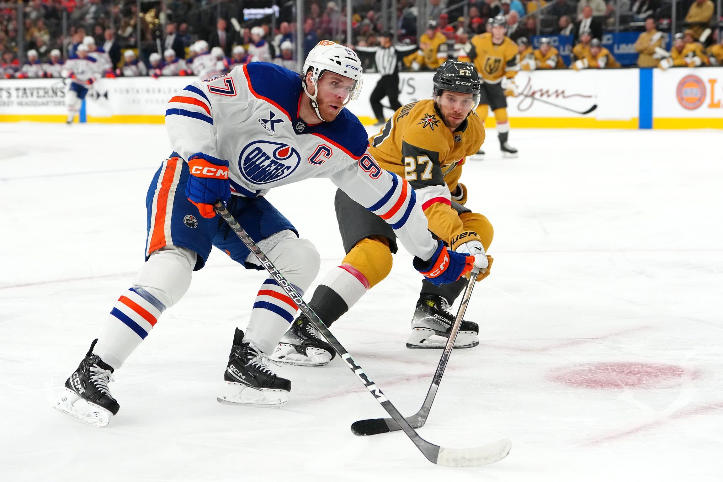 Edmonton Oilers center Connor McDavid (97) protects the puck from Vegas Golden Knights defenseman Shea Theodore (27) during the first period at T-Mobile Arena.