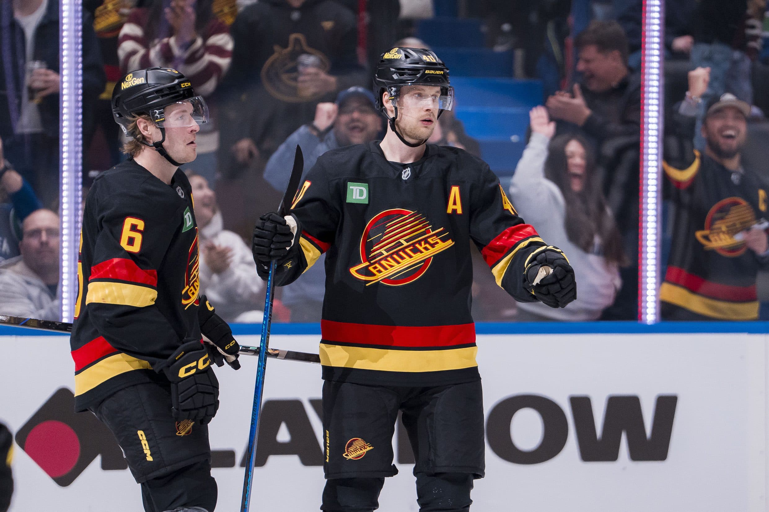 Vancouver Canucks forward Brock Boeser (6) celebrates forward Elias Pettersson (40) goal against the Minnesota Wild during the first period at Rogers Arena.