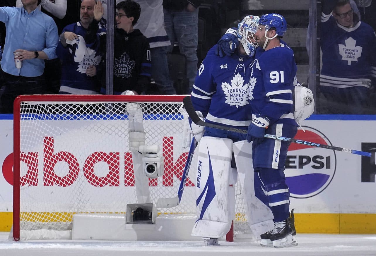 Toronto Maple Leafs forward John Tavares (91) and goaltender Joseph Woll (60) celebrate a win over the Florida Panthers in game one of the second round of the 2025 Stanley Cup Playoffs at Scotiabank Arena.