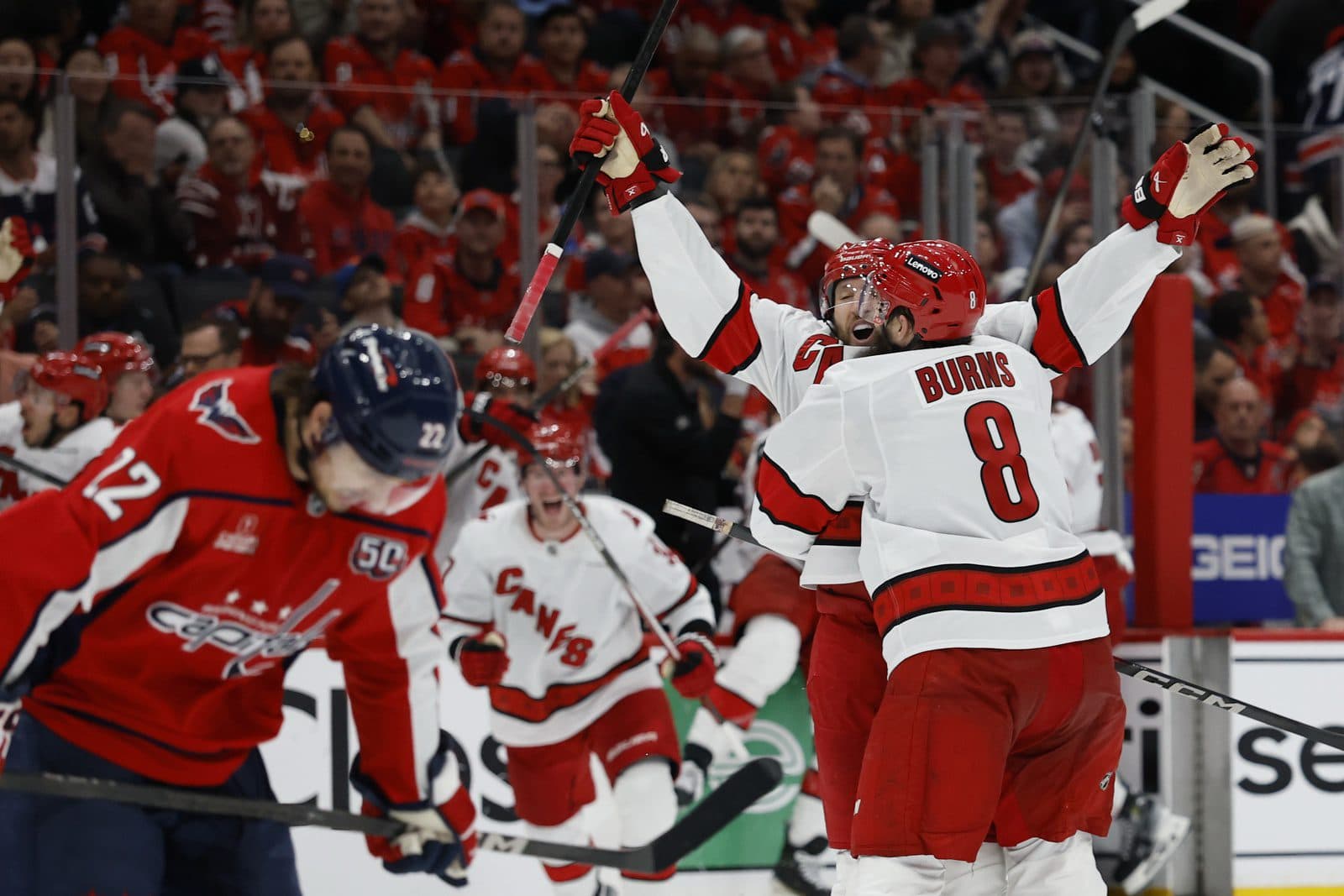 Carolina Hurricanes defenseman Jaccob Slavin (74) celebrates with teammates after scoring the game winning goal in overtime against the Washington Capitals in game one of the second round of the 2025 Stanley Cup Playoffs at Capital One Arena.