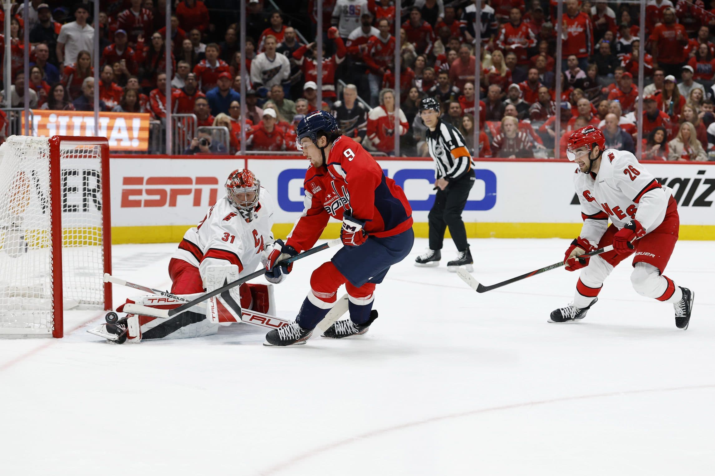 Washington Capitals right wing Ryan Leonard (9) shoots the puck on Carolina Hurricanes goaltender Frederik Andersen (31) as Hurricanes defenseman Sean Walker (26) chases in the third period in game one of the second round of the 2025 Stanley Cup Playoffs at Capital One Arena.