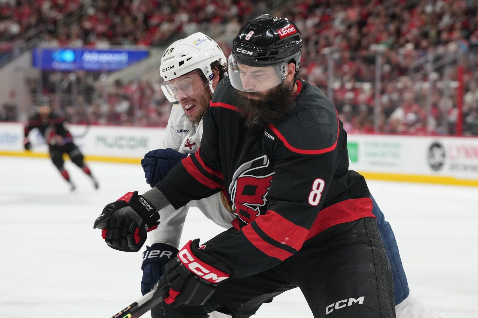 Carolina Hurricanes defenseman Brent Burns (8) defends against Florida Panthers forward Carter Verhaeghe (23) during the second period in game two of the Eastern Conference Final of the 2025 Stanley Cup Playoffs at Lenovo Center.