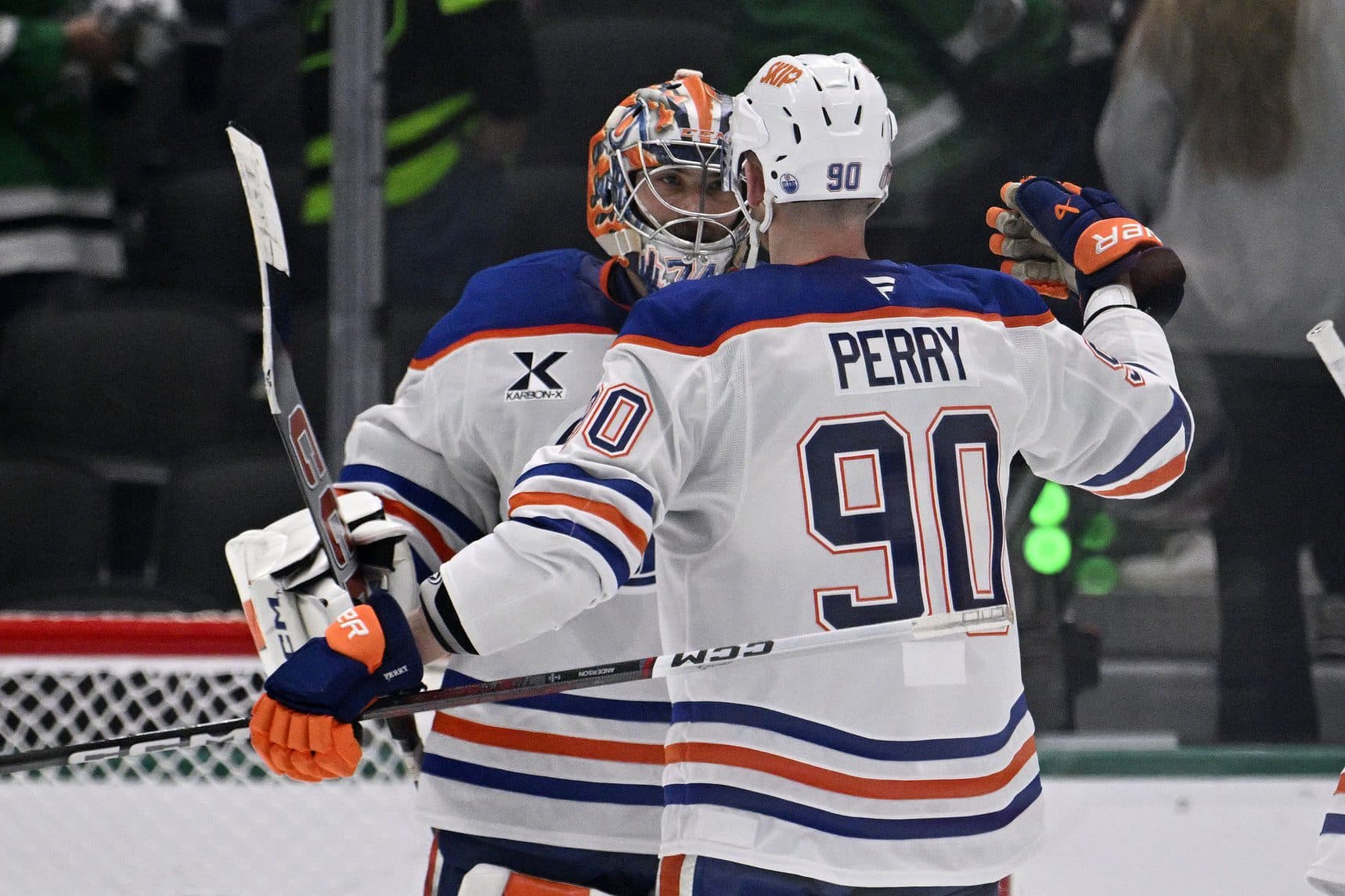 Edmonton Oilers right wing Corey Perry (90) and goaltender Stuart Skinner (74) react after defeating the Dallas Stars in game two of the Western Conference Final of the 2025 Stanley Cup Playoffs at American Airlines Center.