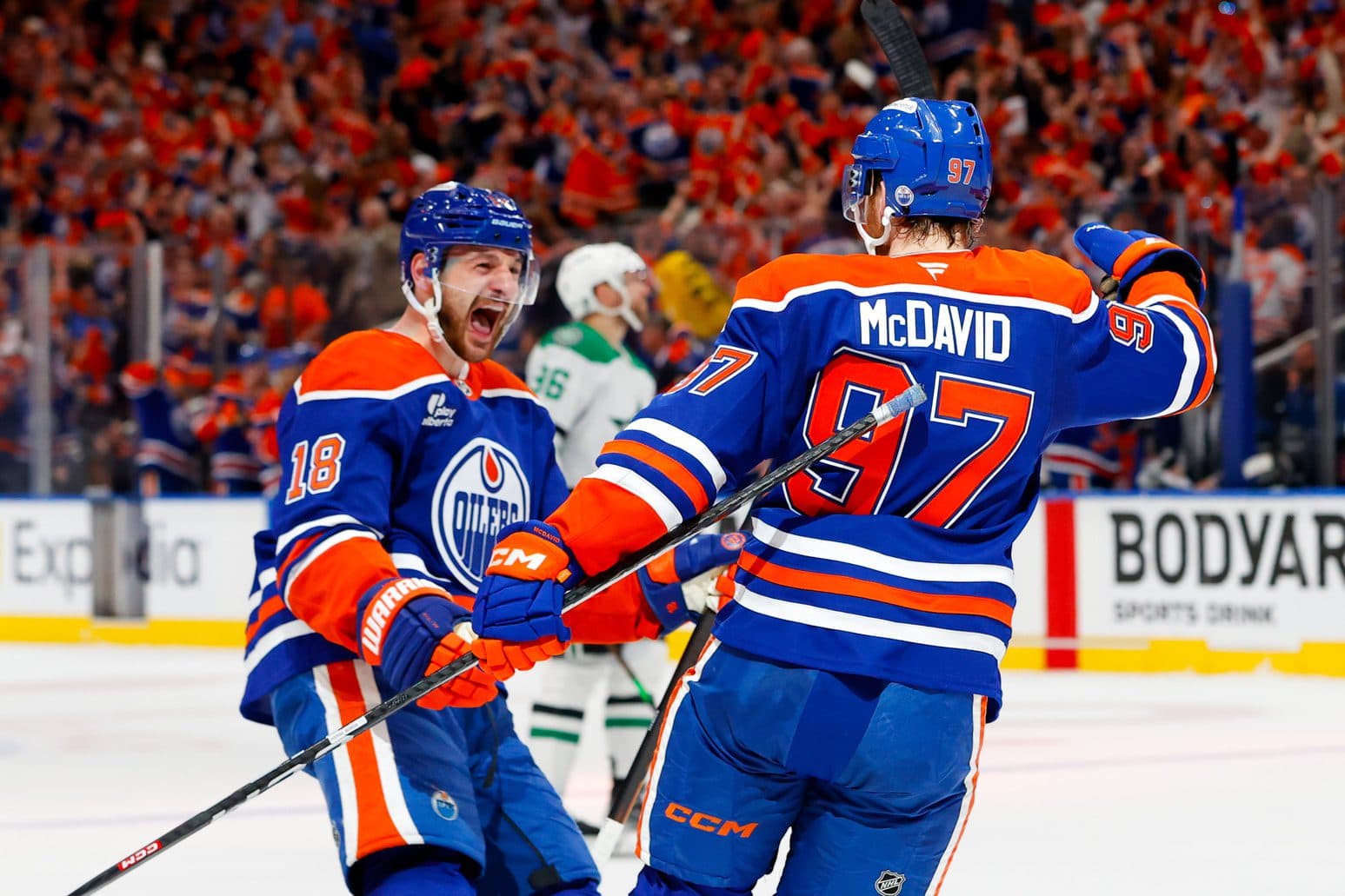 Edmonton Oilers left wing Zach Hyman (18) and center Connor McDavid (97) celebrates a goal scored by McDavid against the Dallas Stars during the first period in game three of the Western Conference Final of the 2025 Stanley Cup Playoffs at Rogers Place.