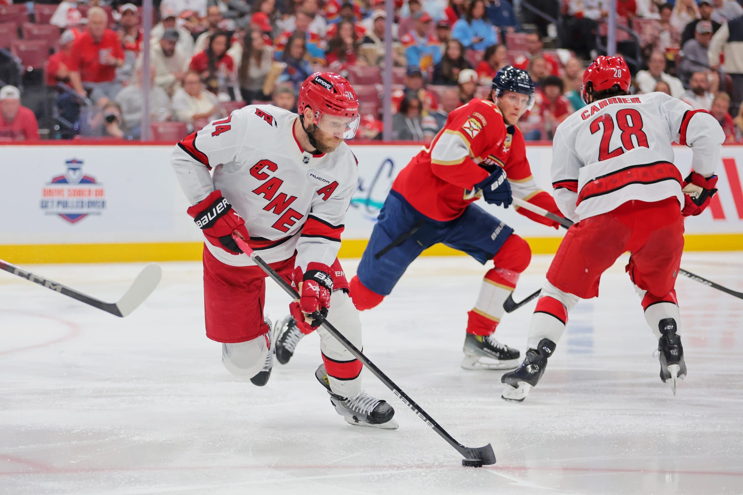 Carolina Hurricanes defenseman Jaccob Slavin (74) moves the puck during the second period against the Florida Panthers in game four of the Eastern Conference Final of the 2025 Stanley Cup Playoffs at Amerant Bank Arena.