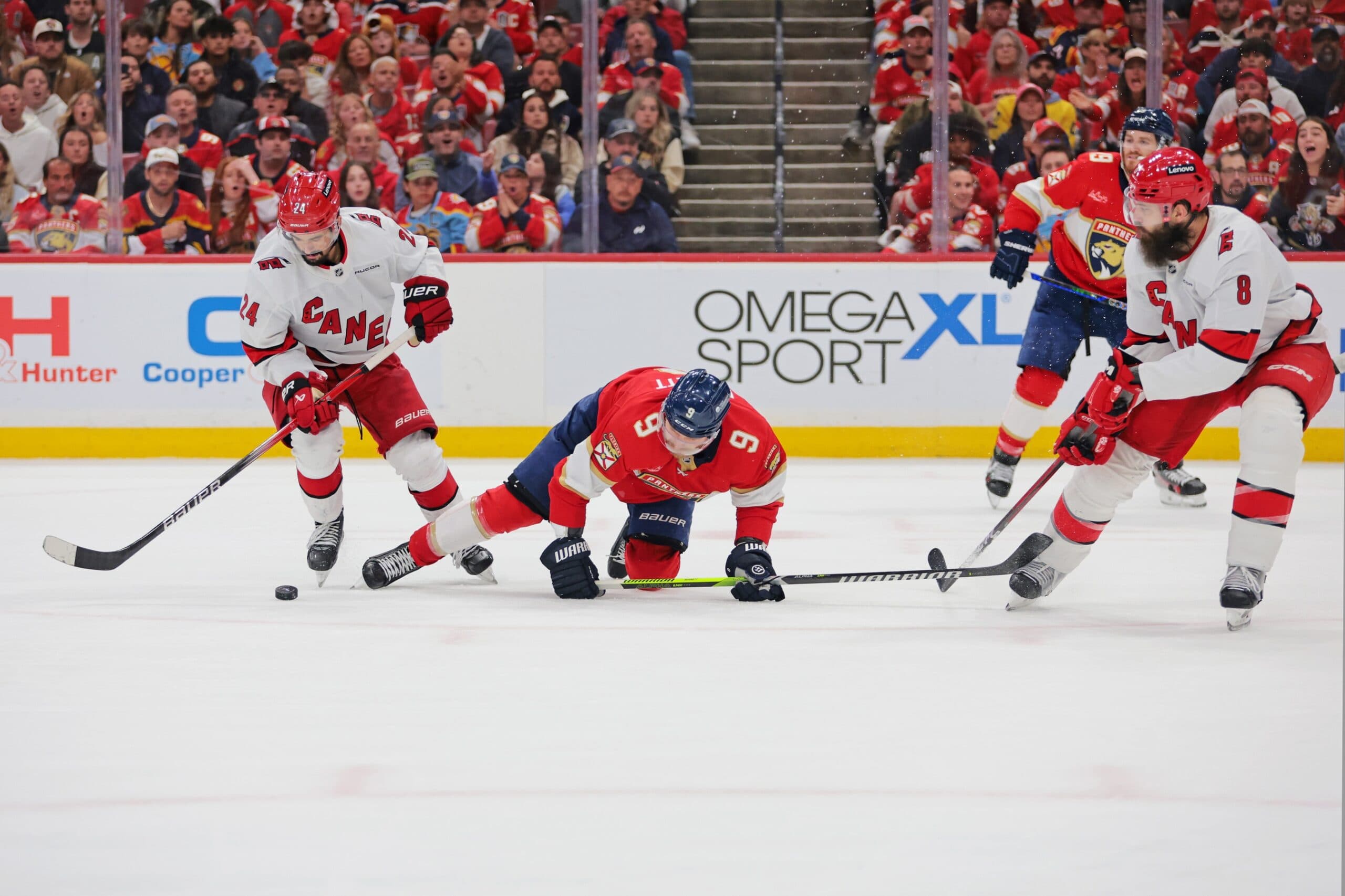 Carolina Hurricanes center Seth Jarvis (24) moves the puck as Florida Panthers center Sam Bennett (9) defends during the third period in game four of the Eastern Conference Final of the 2025 Stanley Cup Playoffs at Amerant Bank Arena.