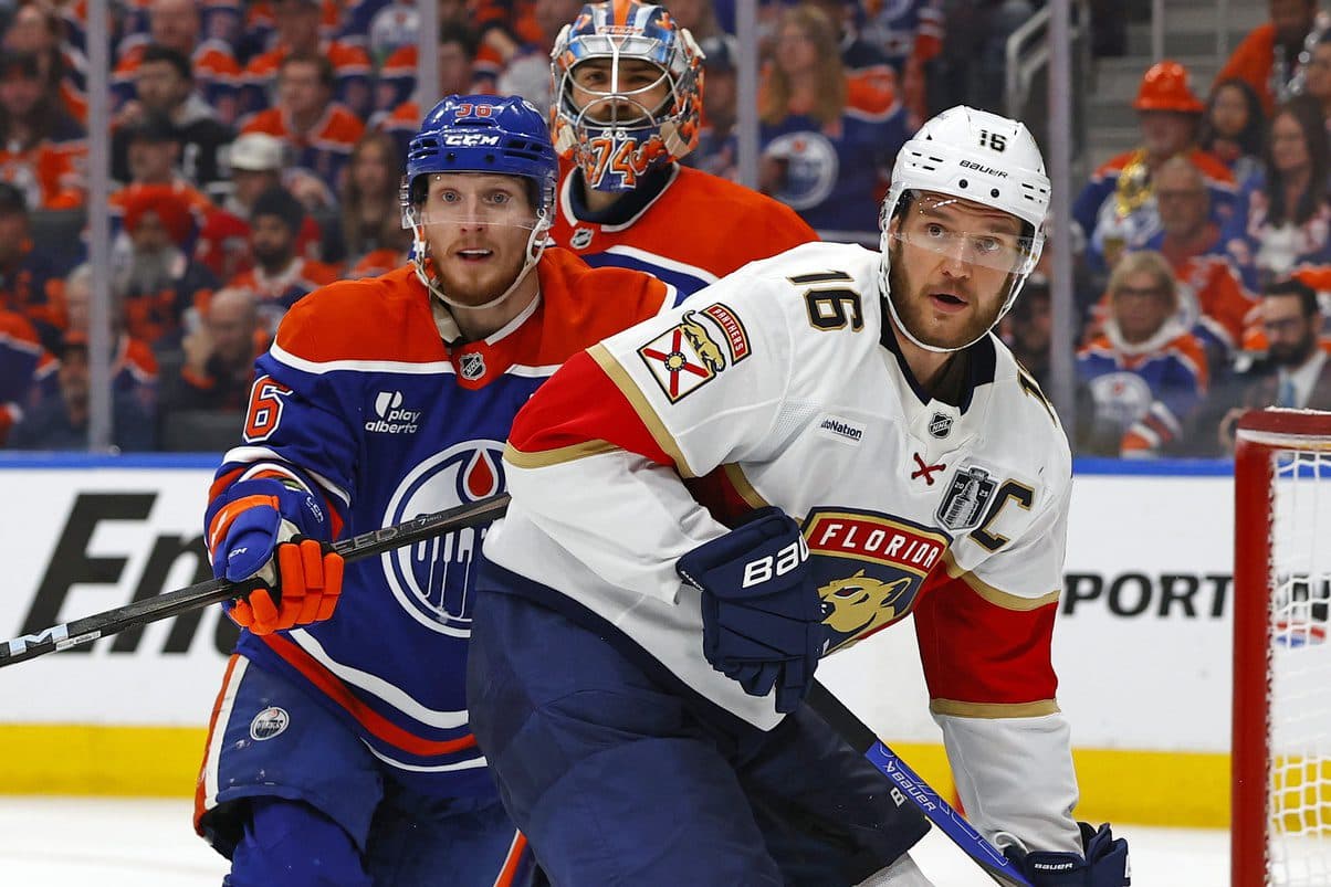 Florida Panthers center Aleksander Barkov (16) and Edmonton Oilers defenseman John Klingberg (36) attempt to get the puck during the second period in game two of the 2025 Stanley Cup Final at Rogers Place.
