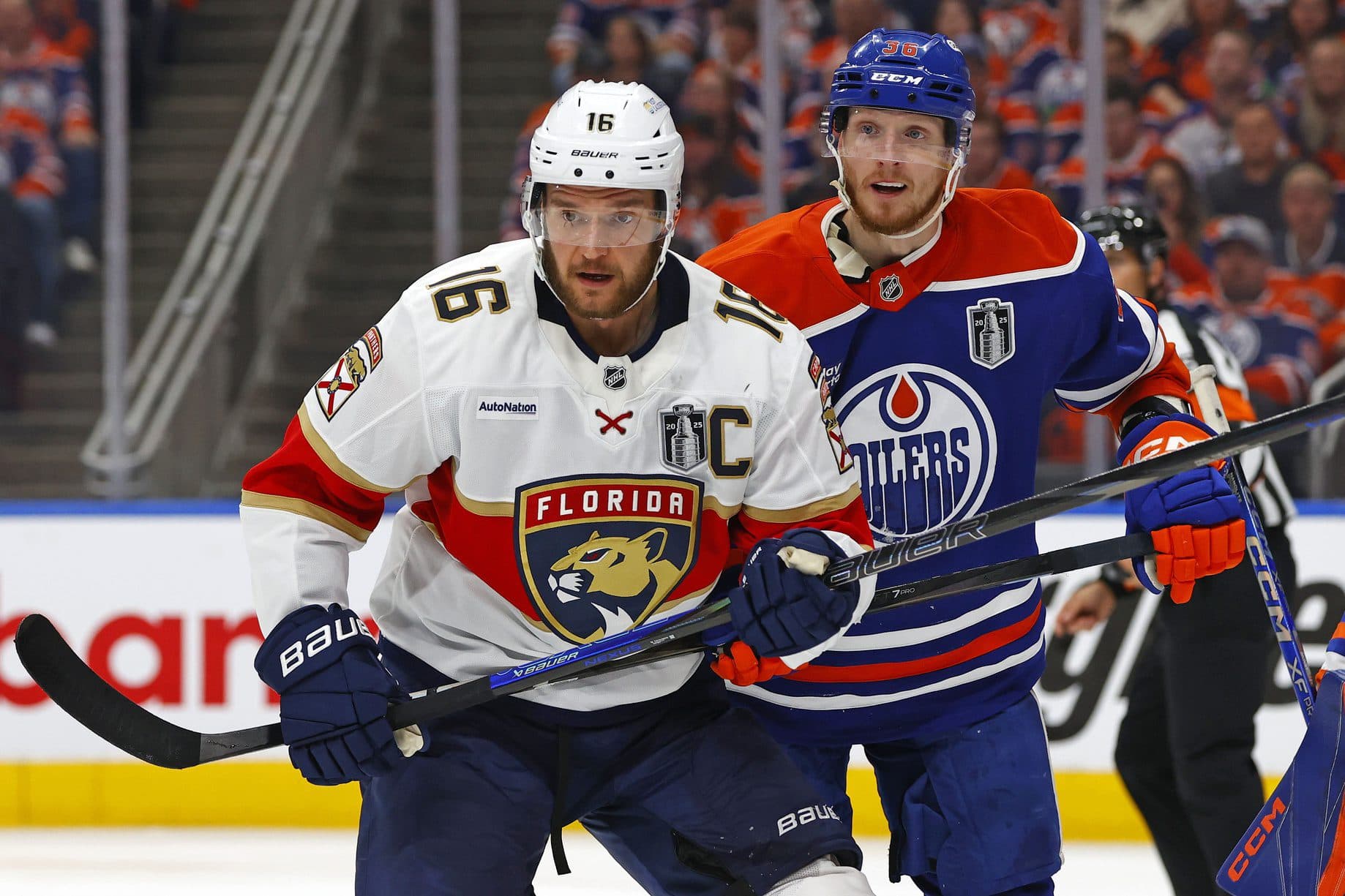 Florida Panthers center Aleksander Barkov (16) and Edmonton Oilers defenseman John Klingberg (36) attempt to get the puck during the second period in game two of the 2025 Stanley Cup Final at Rogers Place.