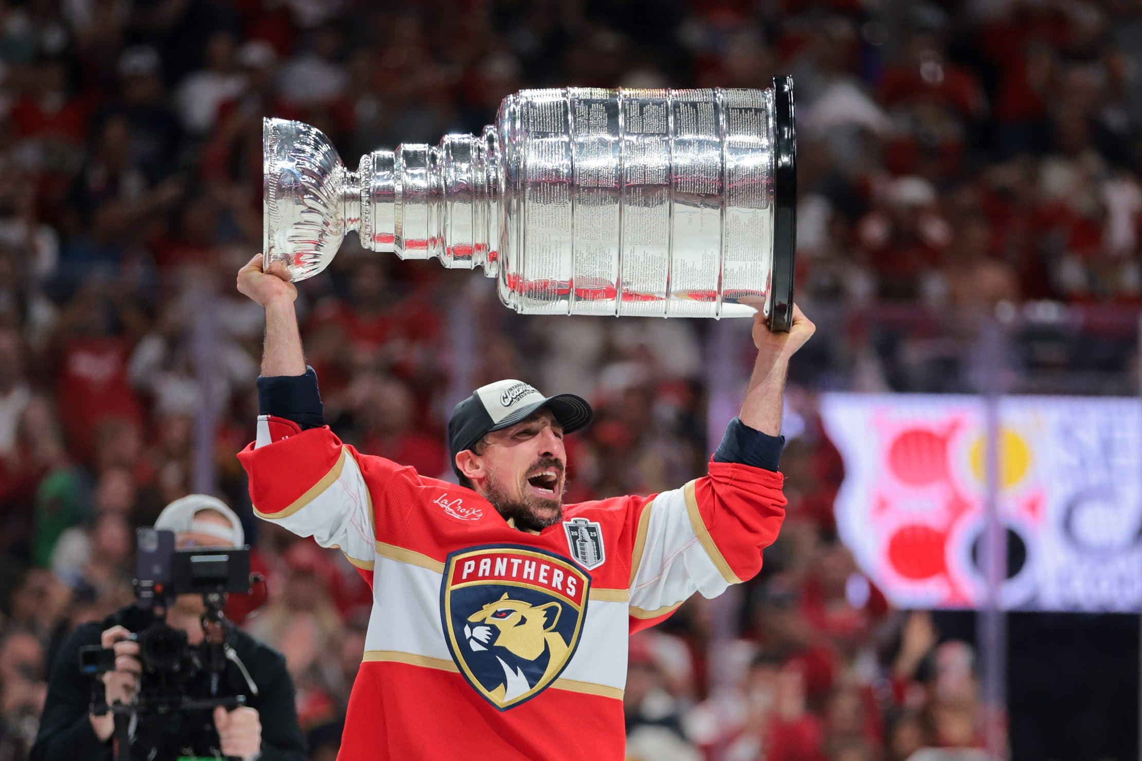 Florida Panthers center Brad Marchand (63) hoists the Stanley Cup after winning game six of the 2025 Stanley Cup Final against the Edmonton Oilers at Amerant Bank Arena.