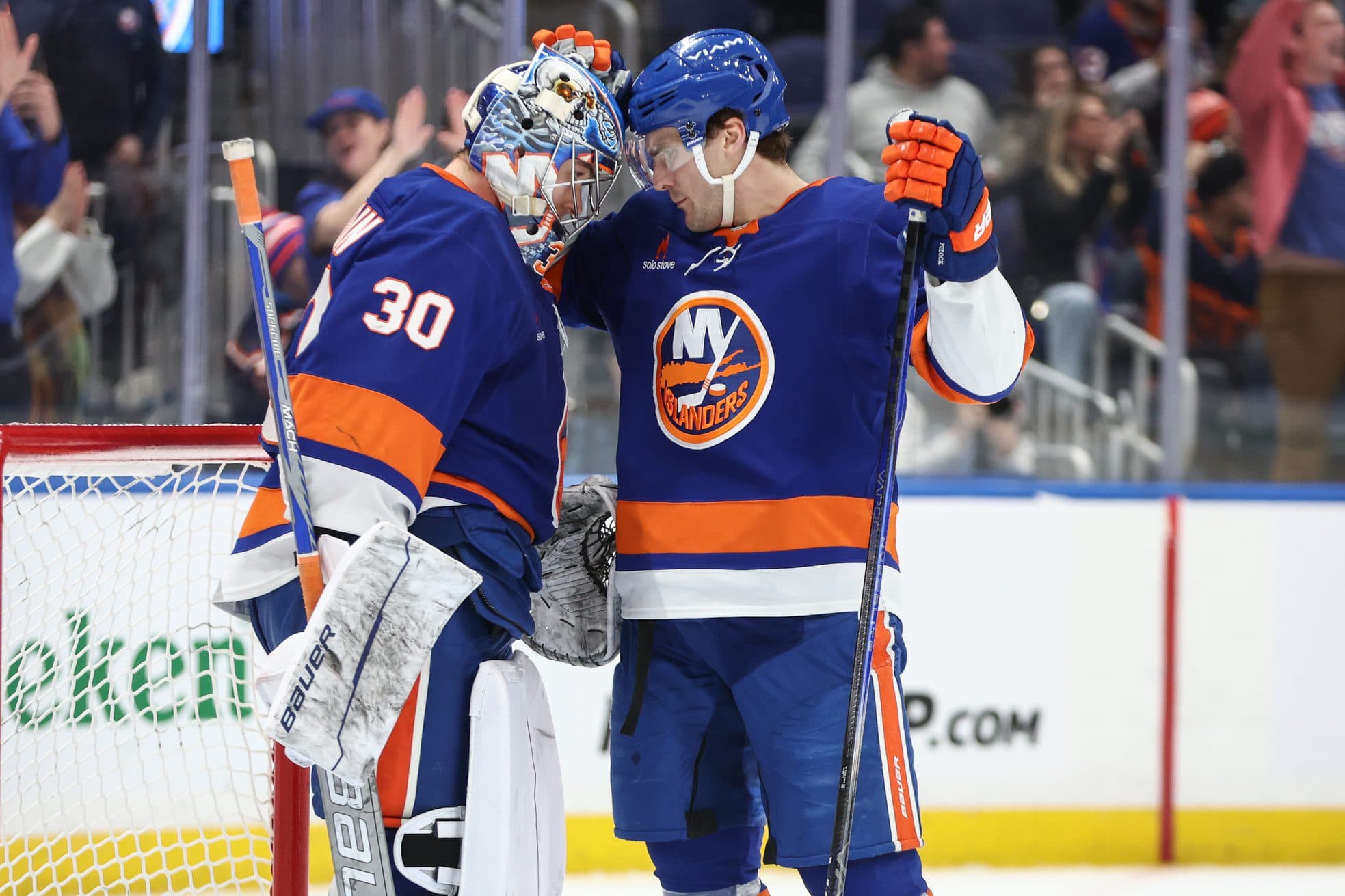 New York Islanders goaltender Ilya Sorokin (30) is greeted by New York Islanders center Mathew Barzal (13) after defeating the Columbus Blue Jackets 3-1 at UBS Arena.