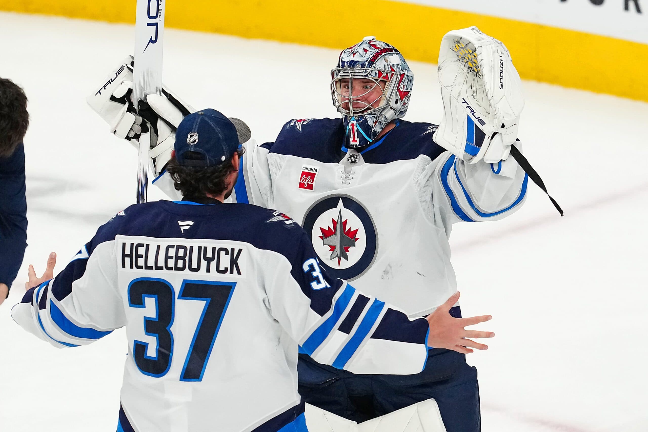 Connor Hellebuyck and Eric Comrie