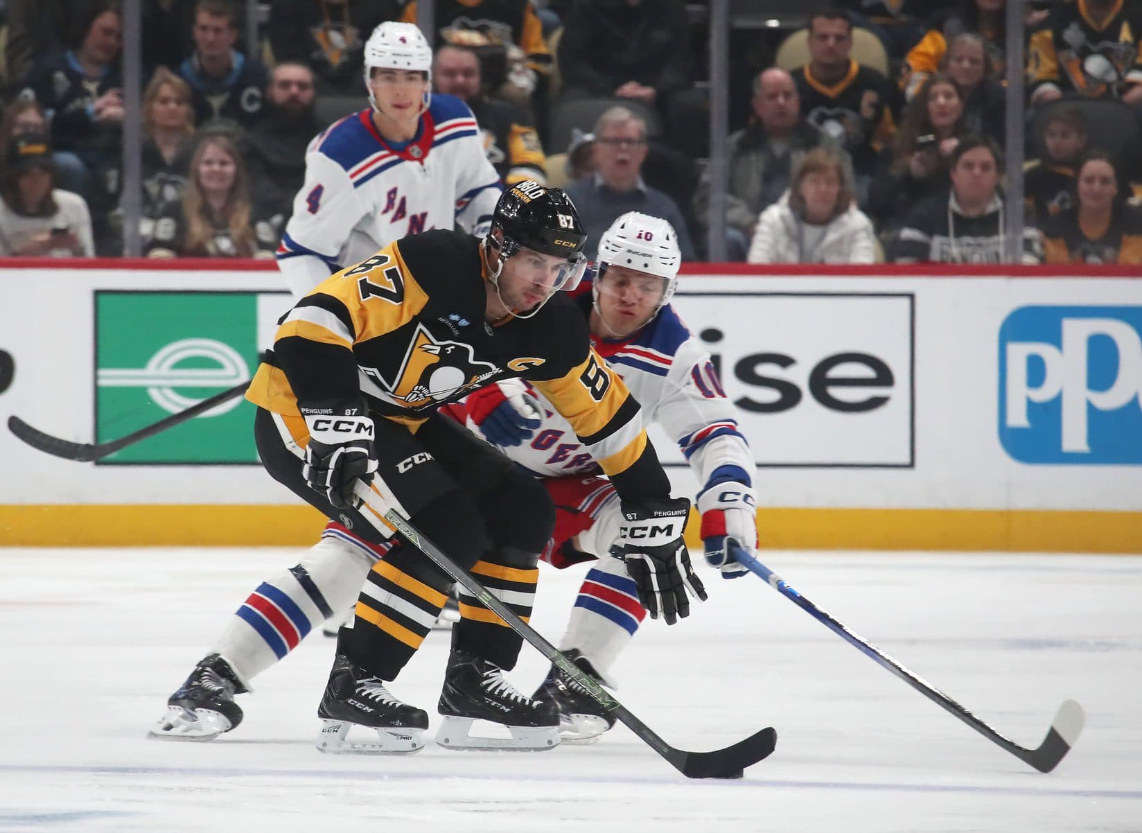 Pittsburgh Penguins center Sidney Crosby (87) shields the puck from New York Rangers left wing Artemi Panarin (10) during the third period at PPG Paints Arena.