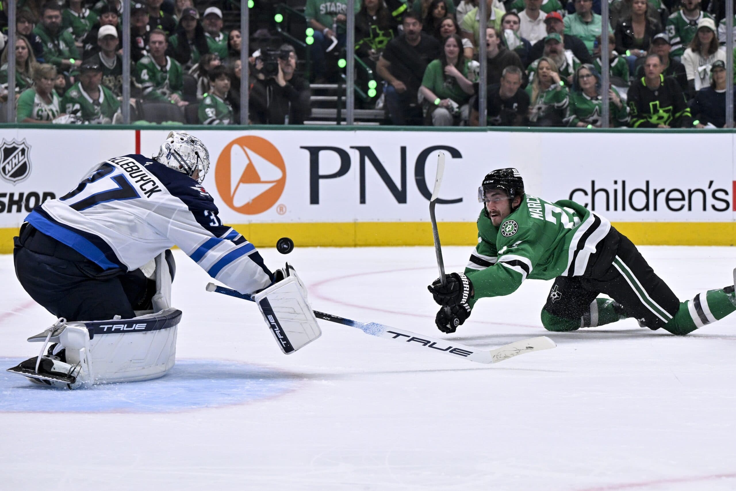 Winnipeg Jets goaltender Connor Hellebuyck (37) and Dallas Stars left wing Mason Marchment (27) in action during the game between the Dallas Stars and the Winnipeg Jets in game three of the second round of the 2025 Stanley Cup Playoffs at American Airlines Center.