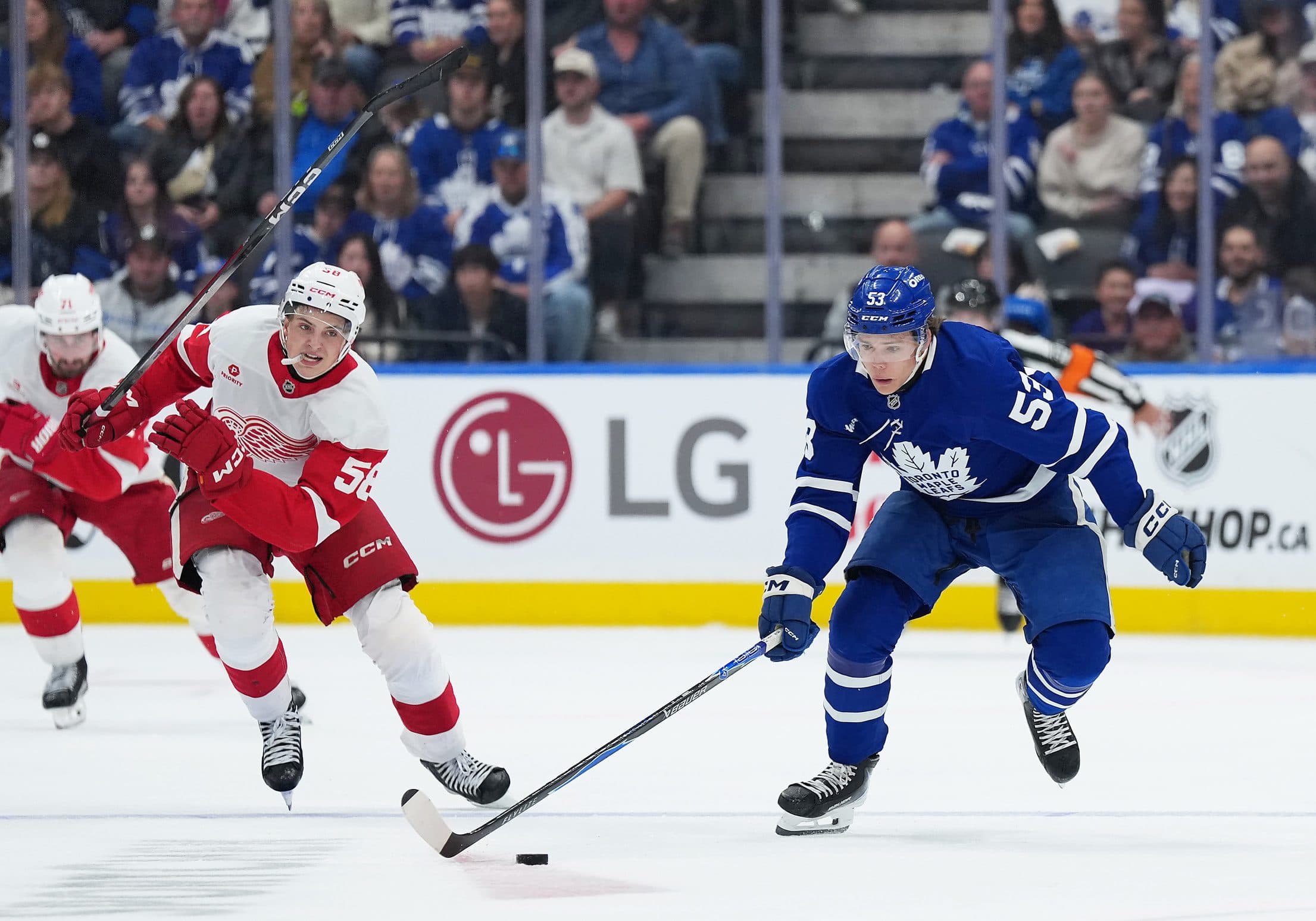 Toronto Maple Leafs right wing Easton Cowan (53) skates with the puck as Detroit Red Wings center Emmitt Finnie (58) gives chase during the third period at Scotiabank Arena.