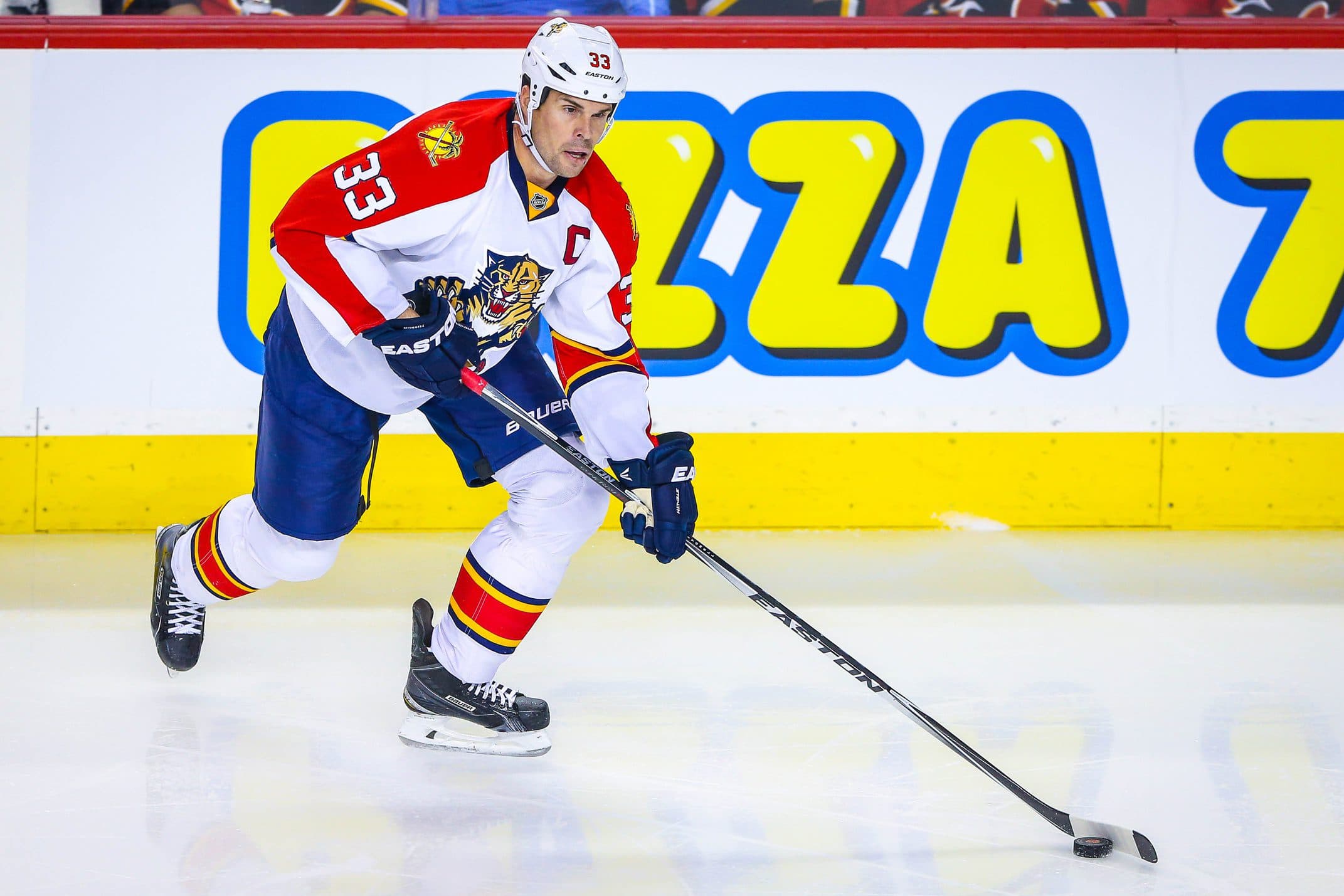 Florida Panthers defenseman Willie Mitchell (33) skates with the puck against the Calgary Flames during the second period at Scotiabank Saddledome. Calgary Flames won 6-0.