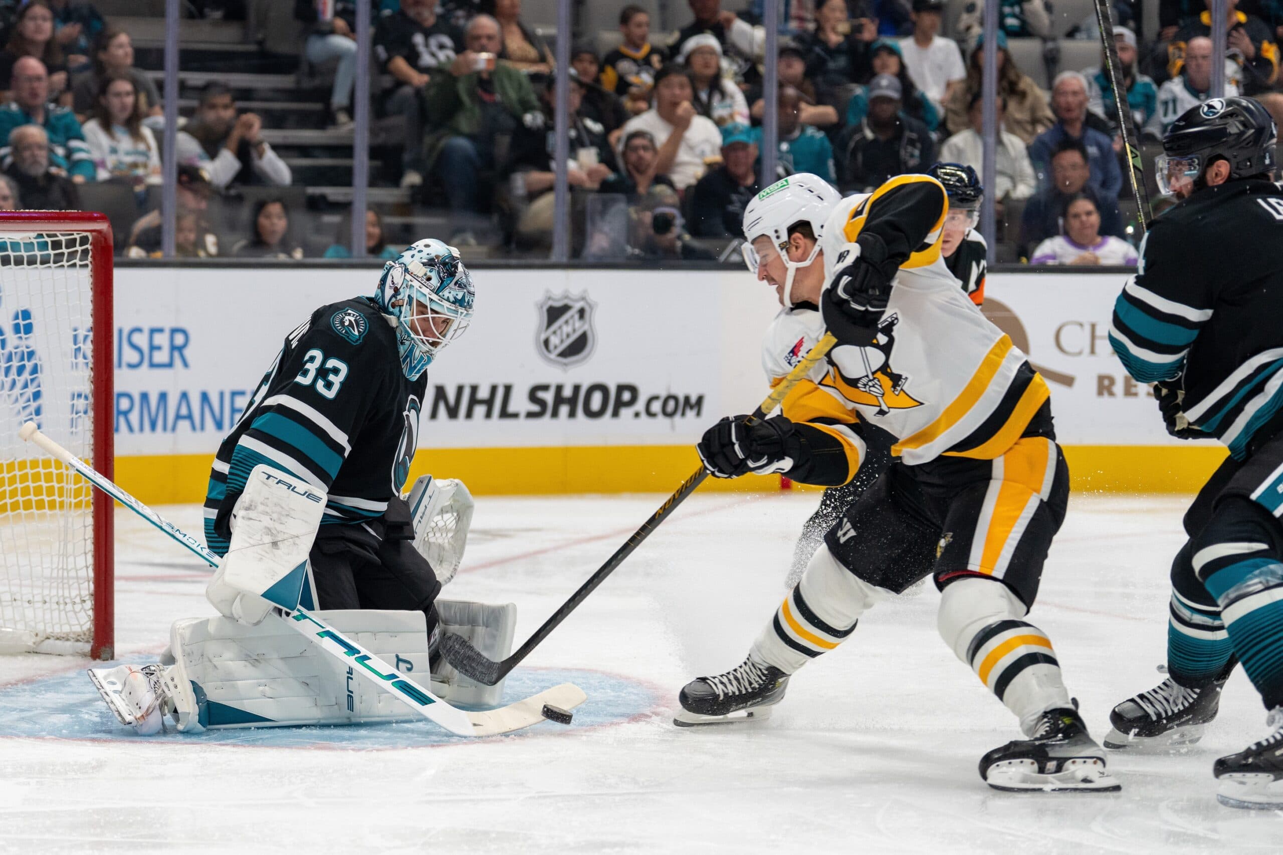 San Jose Sharks goaltender Alex Nedeljkovic (33) makes a save against Pittsburgh Penguins center Noel Acciari (55) during first perioid at SAP Center at San Jose.