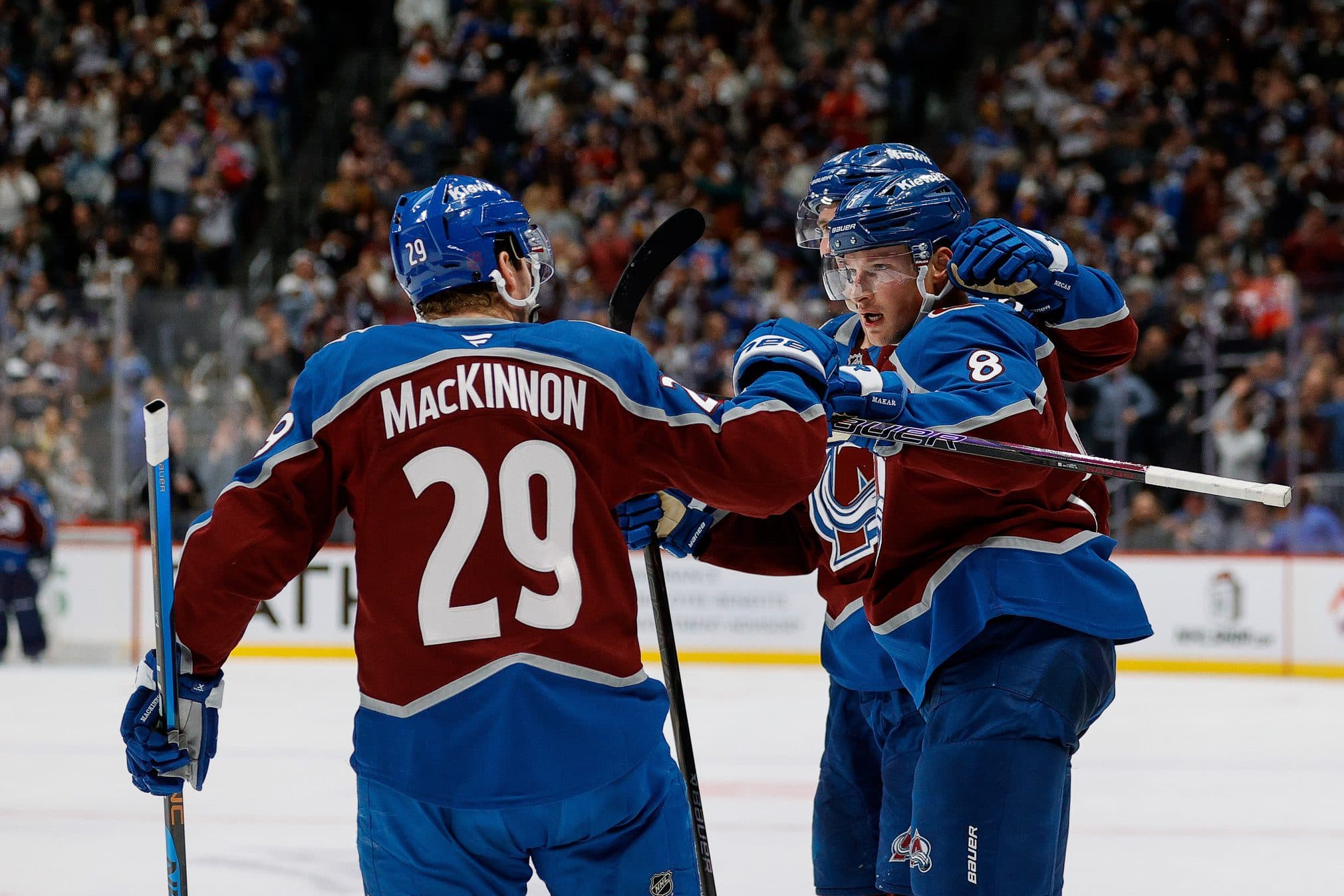 Colorado Avalanche defenseman Cale Makar (8) celebrates his goal with center Martin Necas (88) and center Nathan MacKinnon (29) in the second period against the New York Rangers at Ball Arena.