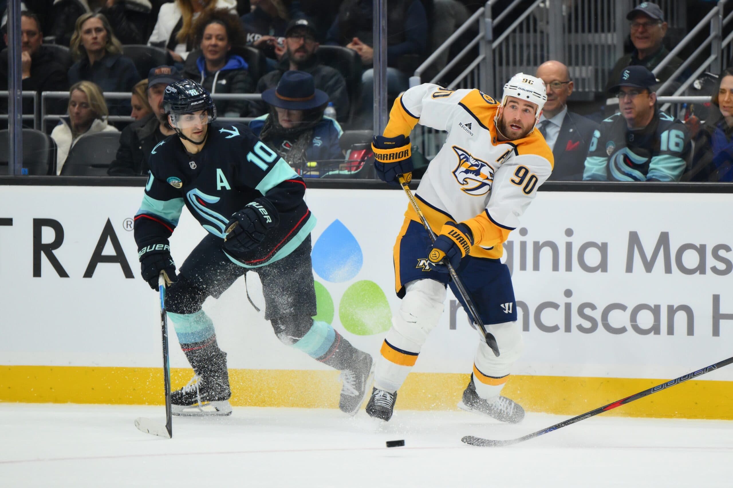 Nashville Predators center Ryan O'Reilly (90) passes the puck while defended by Seattle Kraken center Matty Beniers (10) during the second period at Climate Pledge Arena.